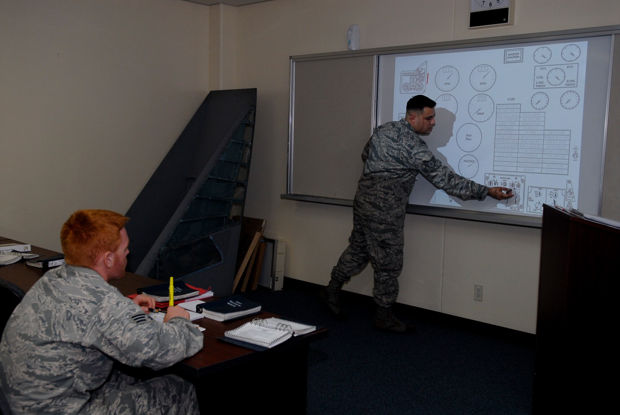 U.S. Air Force Staff Sgt. Michael Lydko, 18th Maintenance Operation Squadron F-15 instructor, teaches an F-15 installed engine run class to familiarize 18th MOS personnel with the gauges and inner workings of the F-15 cockpit on Kadena Air Base, Japan, Oct. 12, 2011. Lydko is part of the 18th MOS maintenance training flight which provides initial, recurring, and advanced proficiency skills needed by technicians to perform their duties. (U.S. Air Force photo/Airman 1st Class Tara A. Williamson)