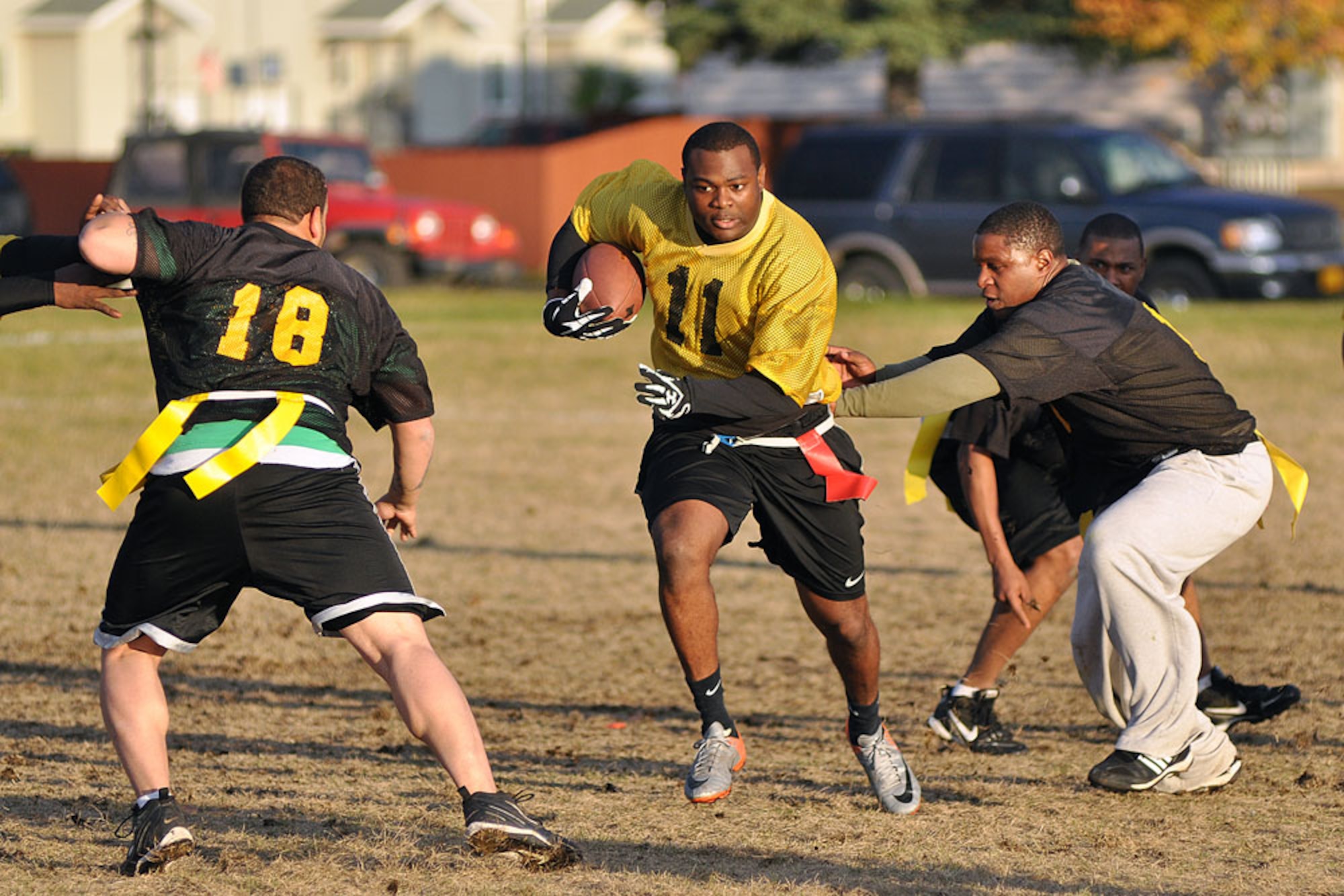A/307th ITSB’s Zeraan Hill looks for daylight between 56th Engineer defenders German Laboy (18) and Gerald Dixon in the “if necessary” championship game of the Joint Base Elmendorf-Richardson intramural flag football tournament Oct. 4 at the Buckner Physical Fitness Center field. ITSB won the first championship game 13-6, forcing the second game. The engineers fought back to win the second game, and the title, 14-6. (U.S. Air Force photo/John Pennell)