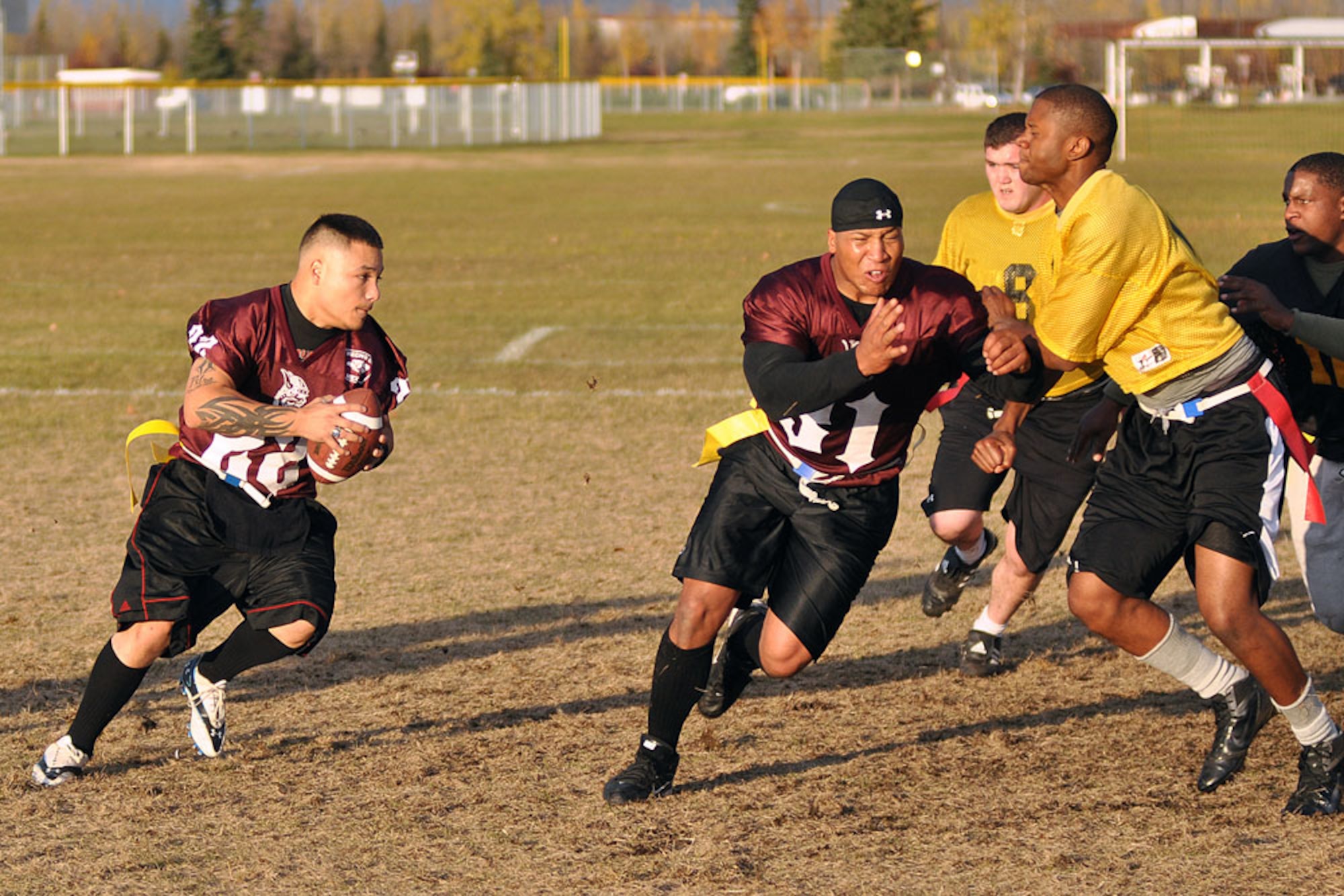 Quarterback Louie Jaramillo looks to follow his blockers during championship action in the Joint Base Elmendorf-Richardson intramural flag football tournament Oct. 4 at the Buckner Physical Fitness Center field. Jaramillo and his 56th Engineer Company teammates lost the first championship game to A Company, 307th Integrated Theater Signal Battalion, 13-6, but came back to win the “if necessary” game 14-6. (U.S. Air Force photo/John Pennell)