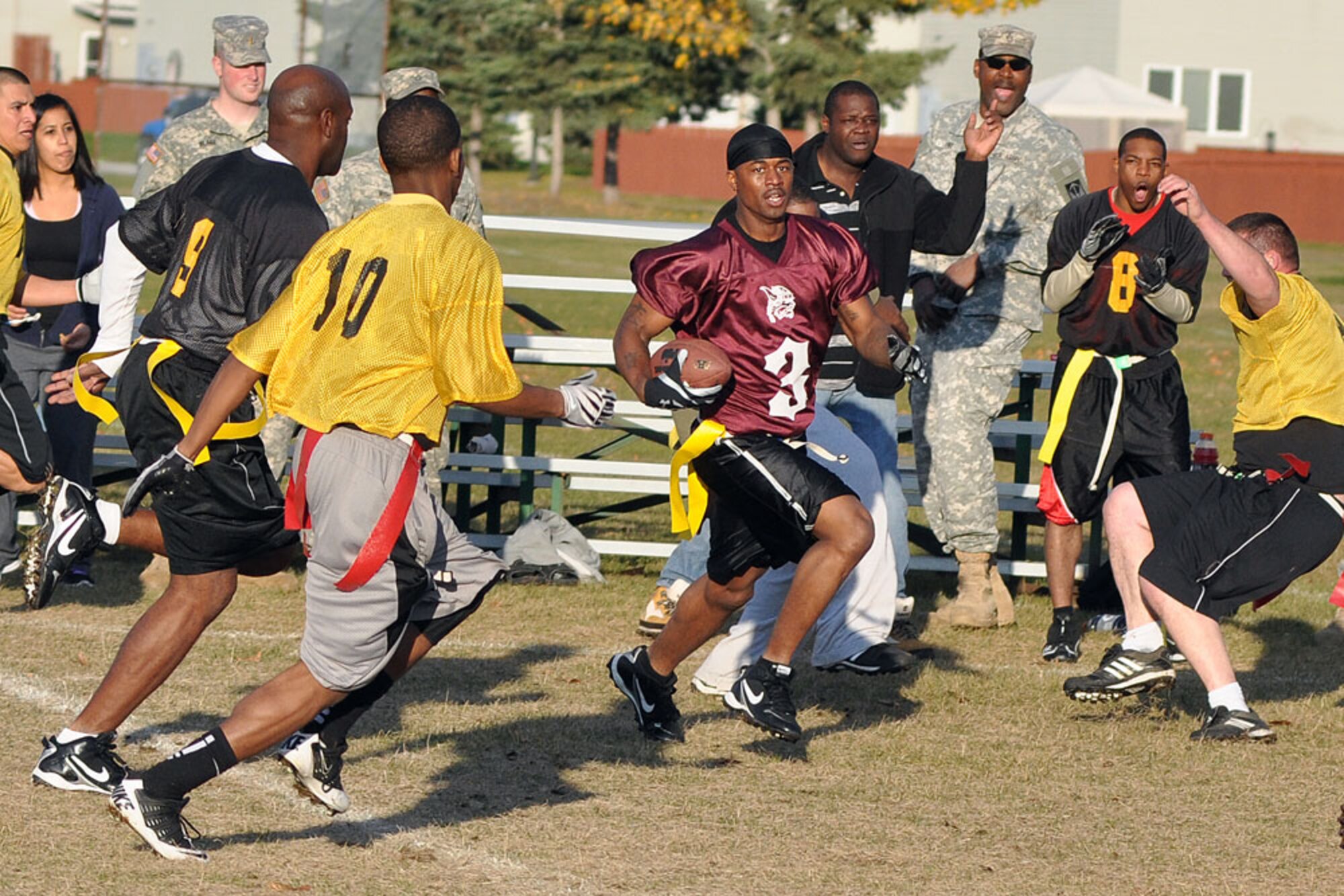Xavier Chance weaves through a crowd of A/307th ITSB defenders for the 56th Engineer Company in the first championship game Oct. 4 at the Buckner Physical Fitness Center field. The engineers lost the first championship game to A/307th ITSB, 13-6, but came back to win the “if necessary” game 14-6. (U.S. Air Force photo/John Pennell)