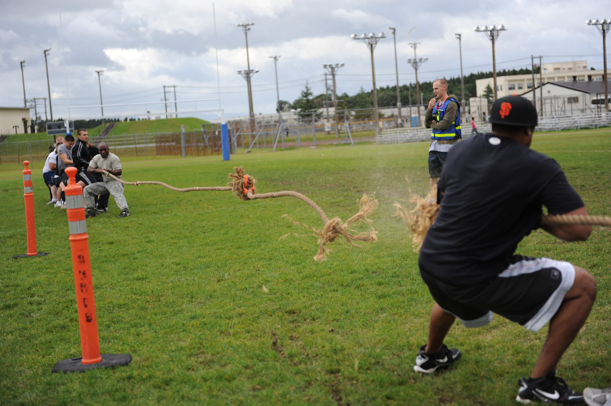 MISAWA AIR BASE, Japan -- A combination of Misawa Security Operations Center and 35th Aircraft Maintenance Squadron members compete against members of the 35th Logistics Readiness Squadron in a game of tug of war during the wing sports day here Oct. 7. Amidst this 'battle of will', the rope snapped under the stress of the two opposing team's exceptional display of sportsmanship. The 35th Fighter Wing held a sports day to promote physical fitness, teamwork, competition, sportsmanship and esprit de corps. The day was kicked off with a 3-mile run followed by various sporting events to include relay races, basketball, softball, ultimate frisbee, soccer and a readiness competition. Approximately 14 units from the base formed teams to participate in each event. (U.S. Air Force photo/Airman 1st Class Kia Atkins)