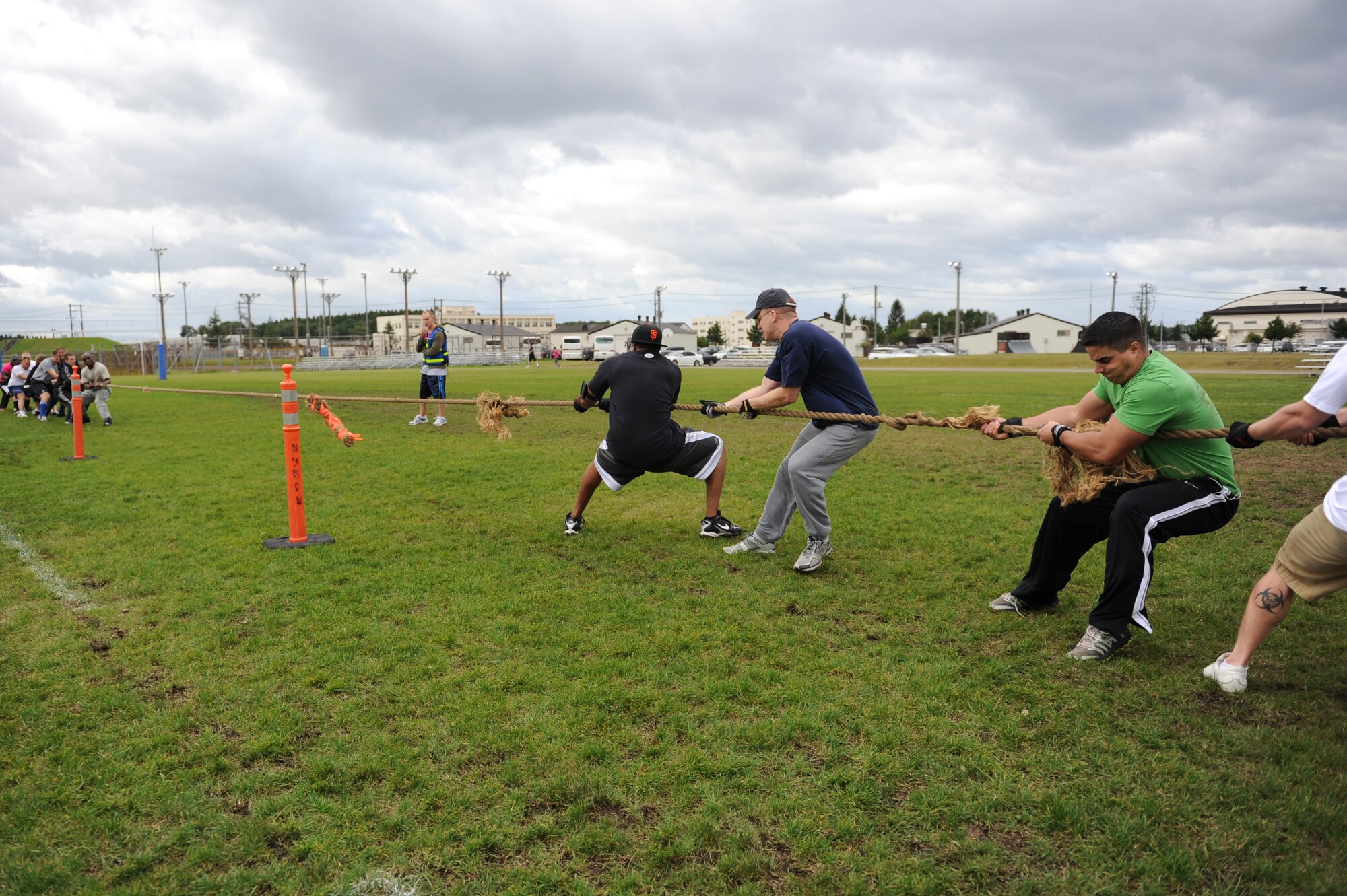 MISAWA AIR BASE, Japan -- A combination of Misawa Security Operations Center and 35th Aircraft Maintenance Squadron members compete against members of the 35th Logistics Readiness Squadron in a game of tug of war, during the wing sports day here Oct. 7. The 35th Fighter Wing held a sports day to promote physical fitness, teamwork, competition, sportsmanship and esprit de corps. The day was kicked off with a 3-mile run followed by various sporting events to include relay races, basketball, softball, ultimate frisbee, soccer and a readiness competition. Approximately 14 units from the base formed teams to participate in each event. (U.S. Air Force photo/Airman 1st Class Kia Atkins)