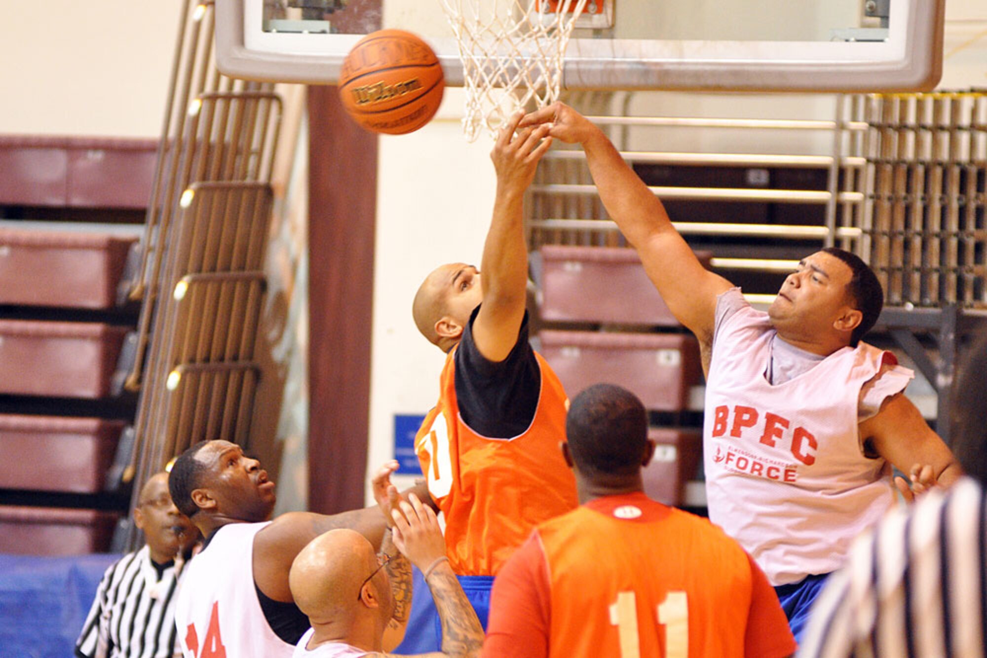 Danilo Silva (white jersey) and Dustin Patrick fight for a rebound.Silva played for HHD, 59th Signal Battalion, while Patrick played for HHB, 2nd Battalion, 377th Parachute Field Artillery Regiment. (U.S. Air Force photo/John Pennell)