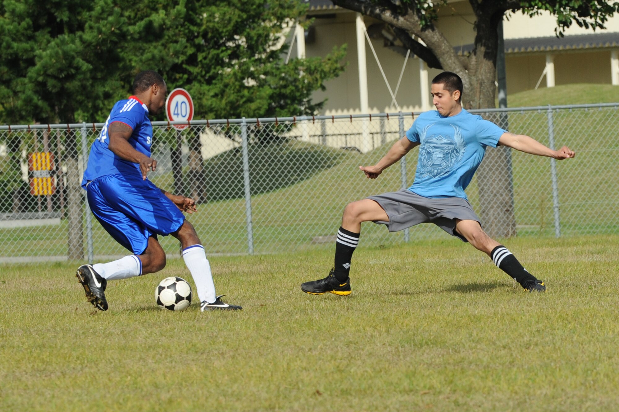MISAWA AIR BASE, Japan -- The 35th Security Forces Squadron and the Navy Aircraft Intermediate Maintenance Detachment members exhibit their soccer skills during a soccer competition during the wing sports day here Oct. 7. The 35th Fighter Wing held a sports day to promote physical fitness, teamwork, competition, sportsmanship and esprit de corps. The day was kicked off with a 3-mile run followed by various sporting events to include relay races, basketball, softball, ultimate frisbee, soccer and a readiness competition. Approximately 14 units from the base formed teams to participate in each event. (U.S. Air Force photo/Airman 1st Class Kia Atkins)