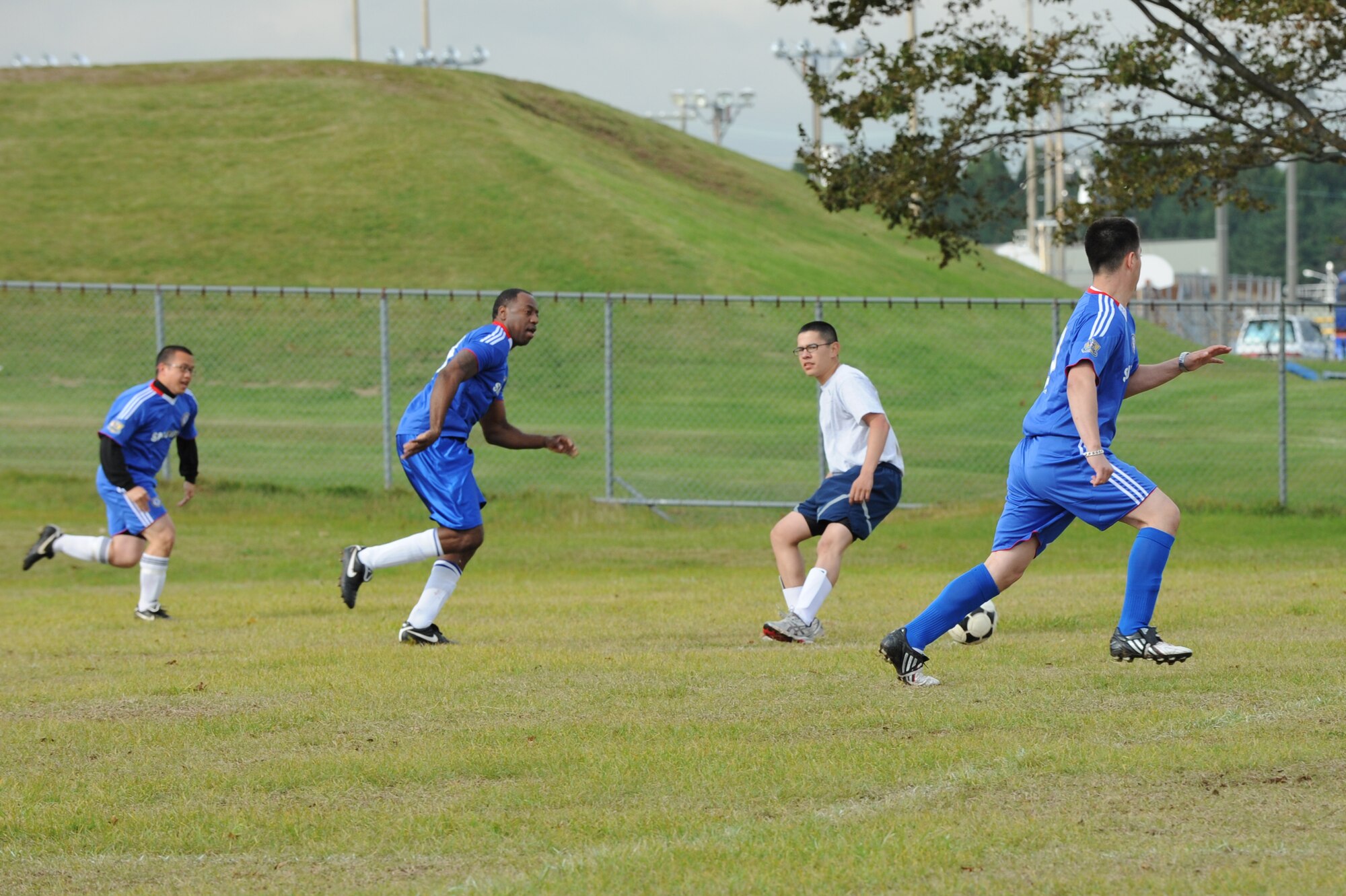 MISAWA AIR BASE, Japan -- The 35th Security Forces Squadron and the Navy Aircraft Intermediate Maintenance Detachment members compete in a soccer match during the wing sports day here Oct. 7. The 35th Fighter Wing held a sports day to promote physical fitness, teamwork, competition, sportsmanship and esprit de corps. The day was kicked off with a 3-mile run followed by various sporting events to include relay races, basketball, softball, ultimate frisbee, soccer and a readiness competition. Approximately 14 units from the base formed teams to participate in each event. (U.S. Air Force photo/Airman 1st Class Kia Atkins)