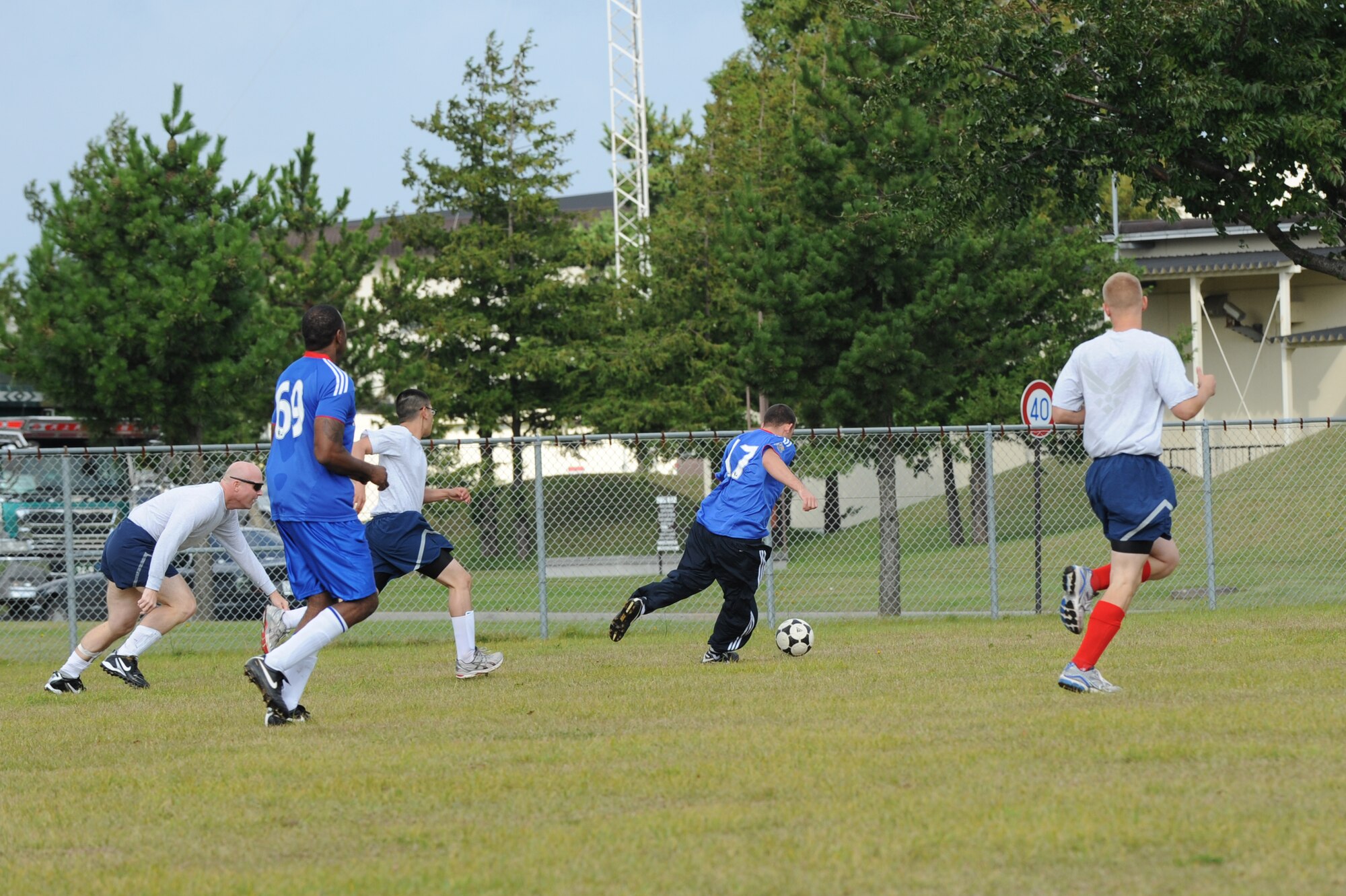 MISAWA AIR BASE, Japan -- The 35th Security Forces Squadron and the Navy Aircraft Intermediate Maintenance Detachment members display teamwork in a soccer competition during the wing sports day here Oct. 7.  The 35th Fighter Wing held a sports day to promote physical fitness, teamwork, competition, sportsmanship and esprit de corps. The day was kicked off with a 3-mile run followed by various sporting events to include relay races, basketball, softball, ultimate frisbee, soccer and a readiness competition. Approximately 14 units from the base formed teams to participate in each event. (U.S. Air Force photo/Airman 1st Class Kia Atkins)