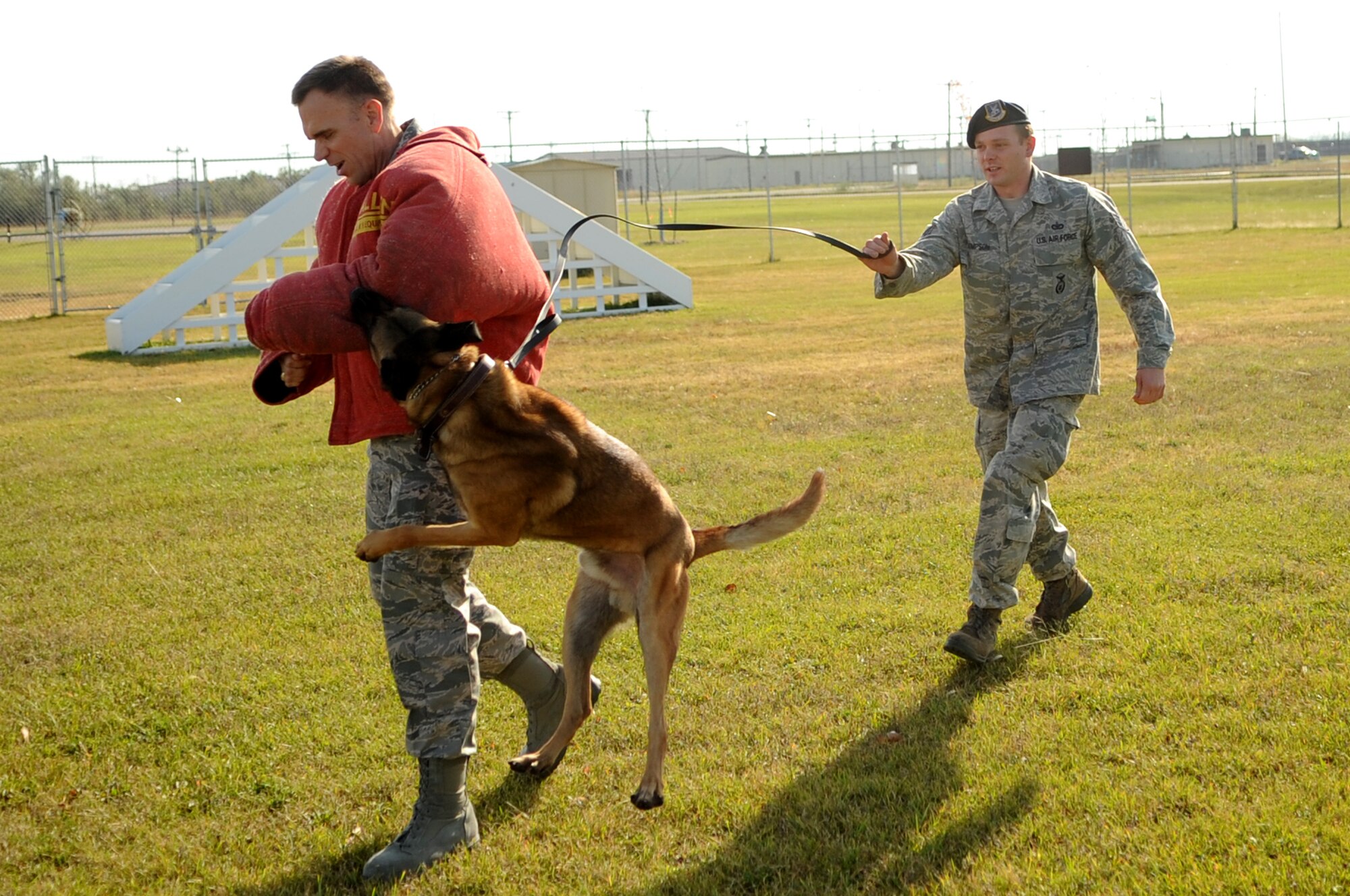 Brig. Gen. Timothy Green, Director of Installations and Mission Support for the U.S. Air Force Air Mobility Command, is “attacked” while running from Zumba and Staff Sgt. Rocky Thompson, 319th Security Forces Squadron K-9 Handler, during a demonstration at Grand Forks Air Force Base, N.D., on Oct. 12. General Green was at Grand Forks for a site visit and to participate in the U.S. Air Force Expeditionary Center Commander’s Conference. (U.S. Air Force photo by Senior Airman Amanda N. Stencil)