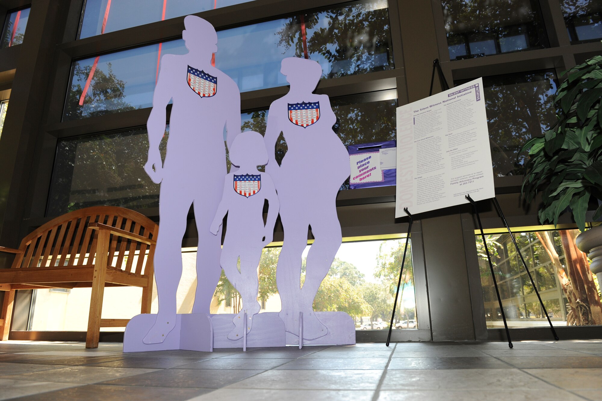 A life-size cutout of a man, woman and child is situated in the lobby of Bldg. 1465, Medical Clinic, to highlight Domestic Violence Awareness month in October. (U.S. Air Force photo by Lisa Norman)