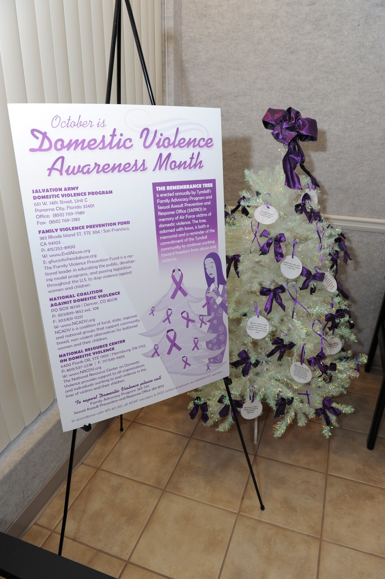 A white tree with purple bows stands in the lobby of Bldg. 1404, Metal Health Clinic, to highlight Domestic Violence Awareness month in October. (U.S. Air Force photo by Lisa Norman) 