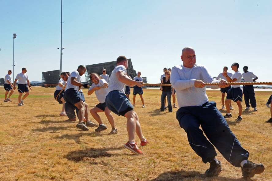 Airmen from 7th Communication Squadron compete in a tug-o-war as a part of the Wingman Olympics, Oct. 7, 2011, at Dyess Air Force Base, Texas. The flight line was used for many activities to include a HUMVEE push, tug-o-war and static displays. (U.S. Air Force photo by Airman 1st Class Peter Thompson/Released)