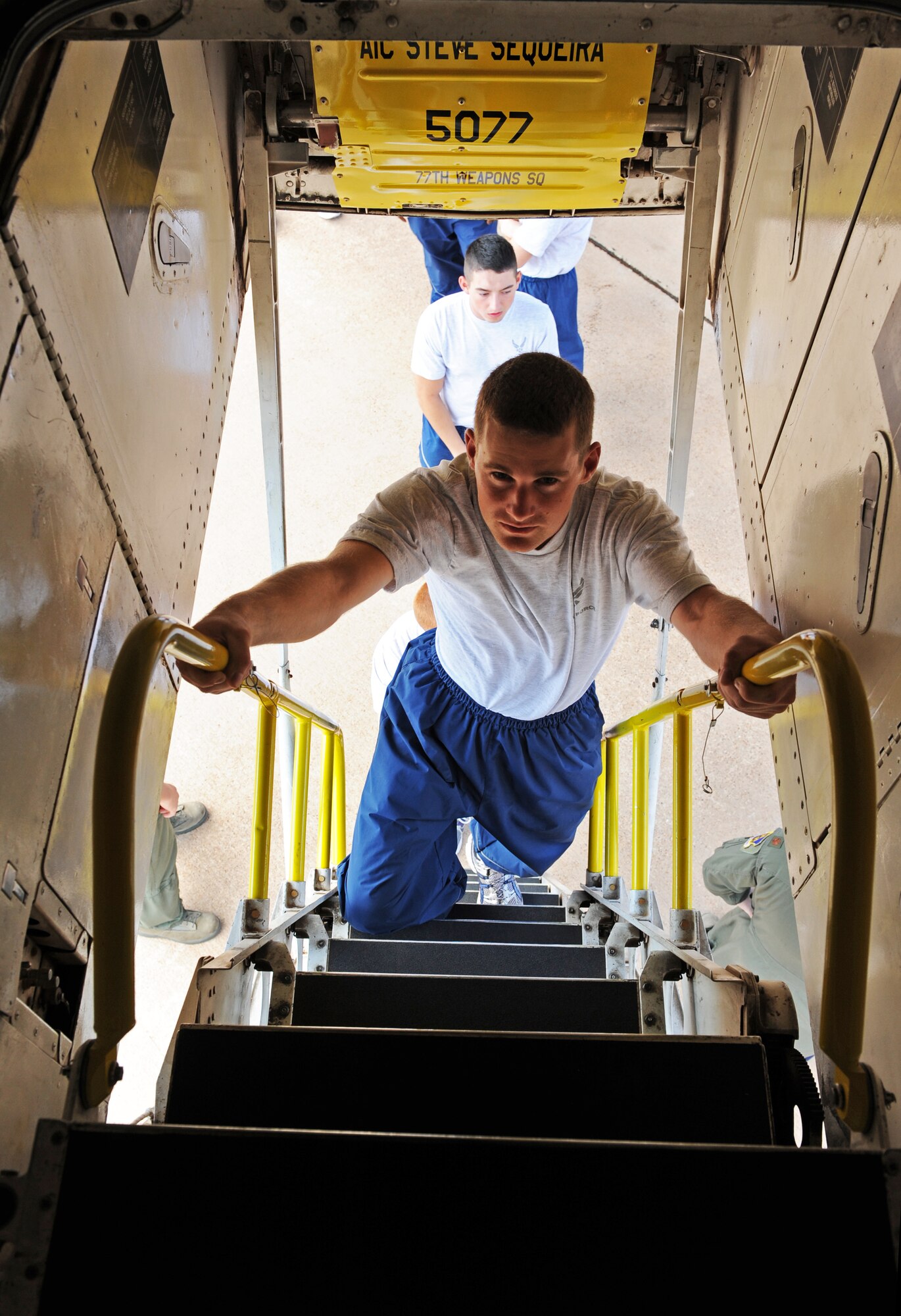 Airman 1st Class Dakota Sizemore, 317th Aircraft Maintenance Squadron, climbs in to the cock pit of a B-1 bomber as a part of Wingman Day, Oct. 7, 2011, at Dyess Air Force Base, Texas. The flight line was used for many activities to include a HUMVEE push, tug-o-war and static displays. (U.S. Air Force photo by Airman 1st Class Peter Thompson/Released)