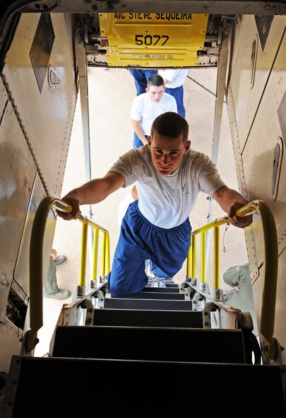 Airman 1st Class Dakota Sizemore, 317th Aircraft Maintenance Squadron, climbs in to the cock pit of a B-1 bomber as a part of Wingman Day, Oct. 7, 2011, at Dyess Air Force Base, Texas. The flight line was used for many activities to include a HUMVEE push, tug-o-war and static displays. (U.S. Air Force photo by Airman 1st Class Peter Thompson/Released)