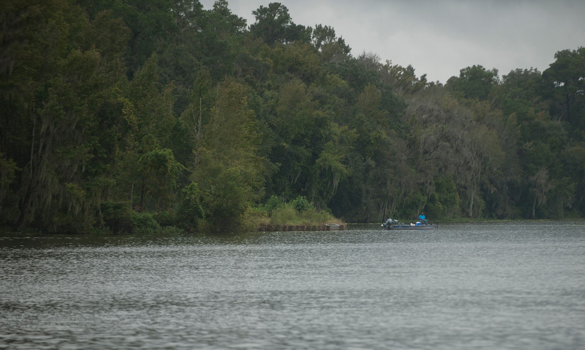 A man fishes from his boat while at Grassy Pond in Valdosta, Ga., Oct. 12, 2011. Grassy Pond is a 500-acre recreation area with a 275-acre pond that has 19 cabins, 39 recreational vehicles, 9 tent sites, four group shelters and a recreational boating area. (U.S. Air Force photo by Airman 1st Class Joshua Green/Released)
