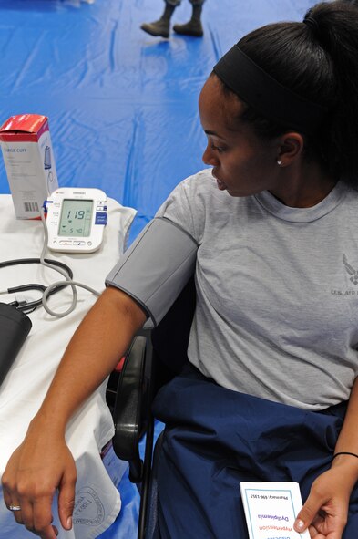 Airman 1st Class Ashley Hawkins, 7th Communication Squadron, has her blood pressure checked at the 7th Medical Group health fair, Oct. 7, 2011, at Dyess Air Force Base, Texas. The health fair was just one of the many events put on for Wingman Day. (U.S. Air Force photo by Airman 1st Class Peter Thompson/Released)