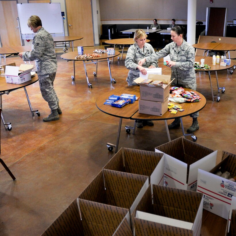 SSgt Amber LaPointe, Lt Col Jane Schotter and  TSgt Allie Truax volunteer their time to assemble numerous care packages for deployed members of the 138th Fighter Wing, Oklahoma Air National Guard, Tulsa OK.  Members of the 138th Fighter Wing were deployed to Southwest Asia on Wednesday, 28 September 2011 in support of Operation New Dawn. 