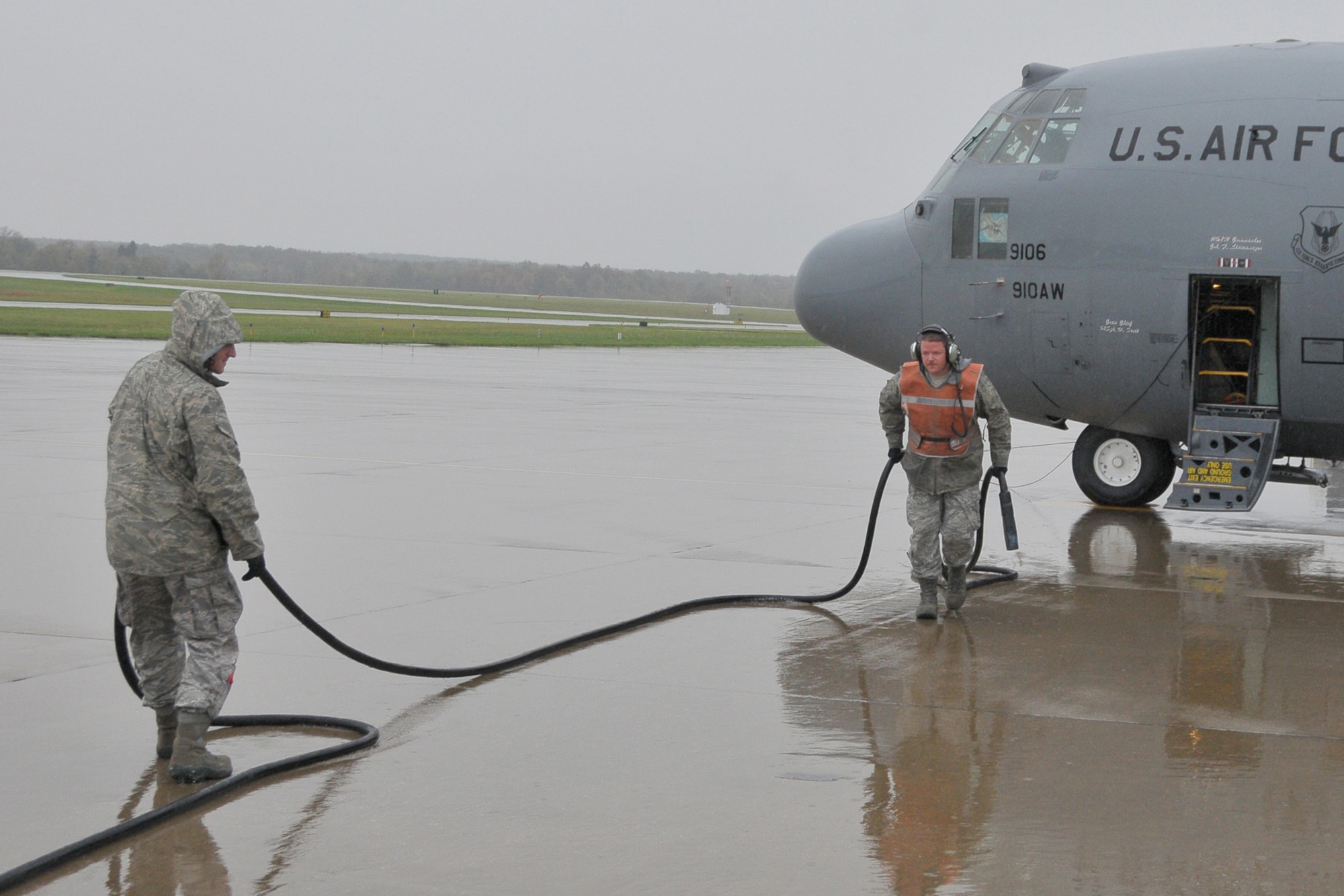 YOUNGSTOWN AIR RESERVE STATION, Ohio -- Air Force Reserve Master Sgt. Dan Scott pulls away the electric generator cable from a C-130H Hercules cargo transport aircraft assigned to the 910th Airlift Wing, with help from Staff Sgt. Justin Smith prior to the aircraft's takeoff from here, Oct. 12, 2011. Sergeants Scott and Smith are C-130 Crew Chiefs for the 910th Aircraft Maintenance Squadron also based here at YARS. U.S. Air Force photo by Tech. Sgt. James Brock