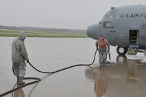 YOUNGSTOWN AIR RESERVE STATION, Ohio -- Air Force Reserve Master Sgt. Dan Scott pulls away the electric generator cable from a C-130H Hercules cargo transport aircraft assigned to the 910th Airlift Wing, with help from Staff Sgt. Justin Smith prior to the aircraft's takeoff from here, Oct. 12, 2011. Sergeants Scott and Smith are C-130 Crew Chiefs for the 910th Aircraft Maintenance Squadron also based here at YARS. U.S. Air Force photo by Tech. Sgt. James Brock