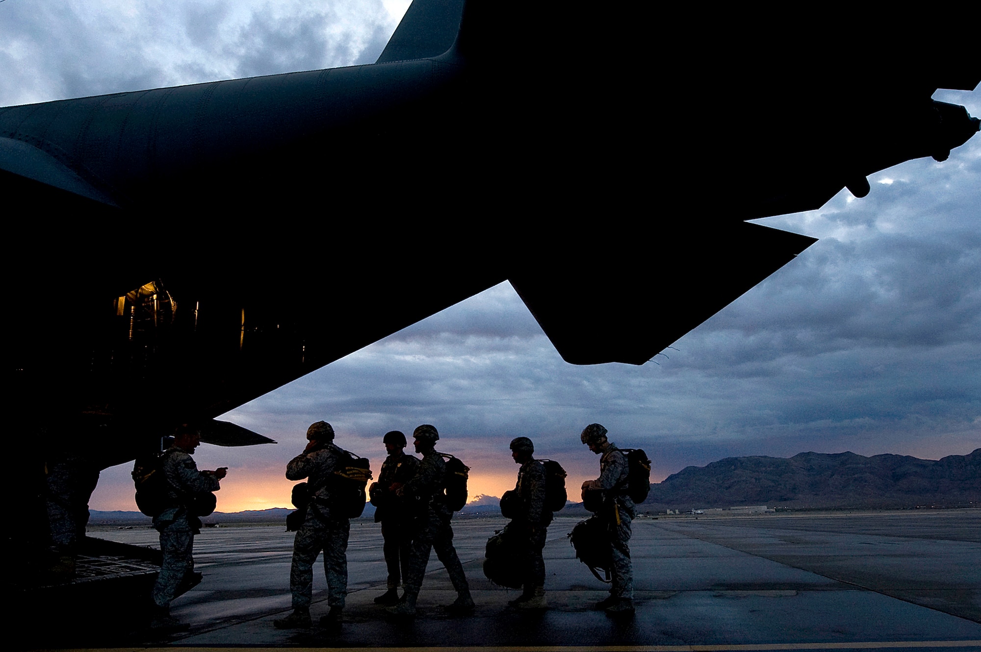 Airmen from the 820th RED HORSE airborne flight and 6th Combat Training Squadron board a C-130 Hercules during a training mission Oct. 4, 2011, at Nellis Air Force Base, Nev. RED HORSE and 6th CTS Airmen perform airdrop missions to stay current on training and certifications, enabling them to perform jump missions and operate their own drop zones. (U.S. Air Force photo/Staff Sgt. Christopher Hubenthal)