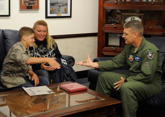 U.S. Air Force Col. Ron Buckley, 366th Fighter Wing commander, meets with Carson McIe, Oct. 5 2011, at Mountain Home Air Force Base, Idaho. The 14-year-old high school freshman from Galion, Ohio, was coined by Col. Buckley for supporting the 389th Aircraft Maintenance Unit during a seven-month deployment to Afghanistan. (U.S. Air Force photo by Senior Airman Angelina Drake/Released) 


