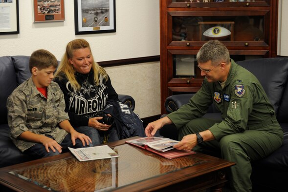 U.S. Air Force Col. Ron Buckley, 366th Fighter Wing commander, flips through a scrap book created by Angela Hoffman, mother of Carson McIe, Oct. 5, 2011, at Mountain Home Air Force Base, Idaho. Members of the 389th Aircraft Maintenance Unit flew Carson and his parents here and sponsored a base tour as a thank you for raising more than $1,000 worth of care packages during the unit’s deployment. (U.S. Air Force photo by Senior Airman Angelina Drake/Released) 

