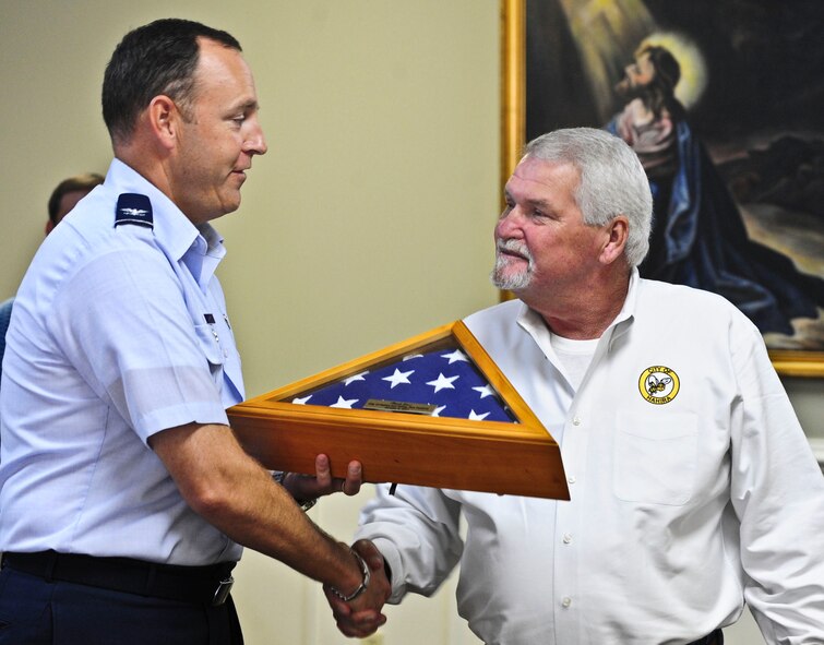 U.S. Air Force Col. Christopher Short, 23rd Wing vice commander, accepts an American flag after the Honeybee Festival parade in Hahira, Ga., Oct. 8, 2011. The flag was folded during a retreat ceremony by the American Legion. (U.S. Air Force photo by Staff Sgt. Stephanie Mancha/Released)