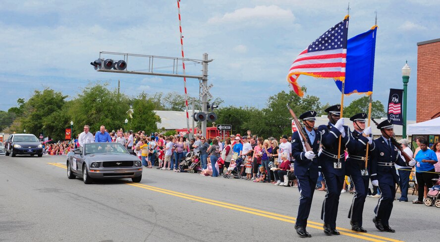 Moody Air Force Base Honor Guard members carry both the American and U.S. Air Force flags at the beginning of the Honeybee Festival parade in Hahira, Ga., Oct. 8, 2011. The Honeybee Festival is an annual event established in 1981 and has since become one of the largest festivals in South Georgia; attracting thousands each year, features arts, crafts, a beauty pageant and a parade. (U.S. Air Force photo by Staff Sgt. Stephanie Mancha/Released)