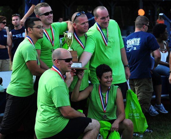 The 628th Civil Engineer Squadron's Lime Green Team pose for a photo after accepting the trophy for winning the Festival of Fitness, Oct. 7, at Joint Base Charleston. Seventeen, six-man teams competed in the Festival of Fitness which included a 5k run, tug-of-war, trivia questions and a team fitness relay.  (U.S. Air Force photo/ Staff Sgt. Nicole Mickle)    