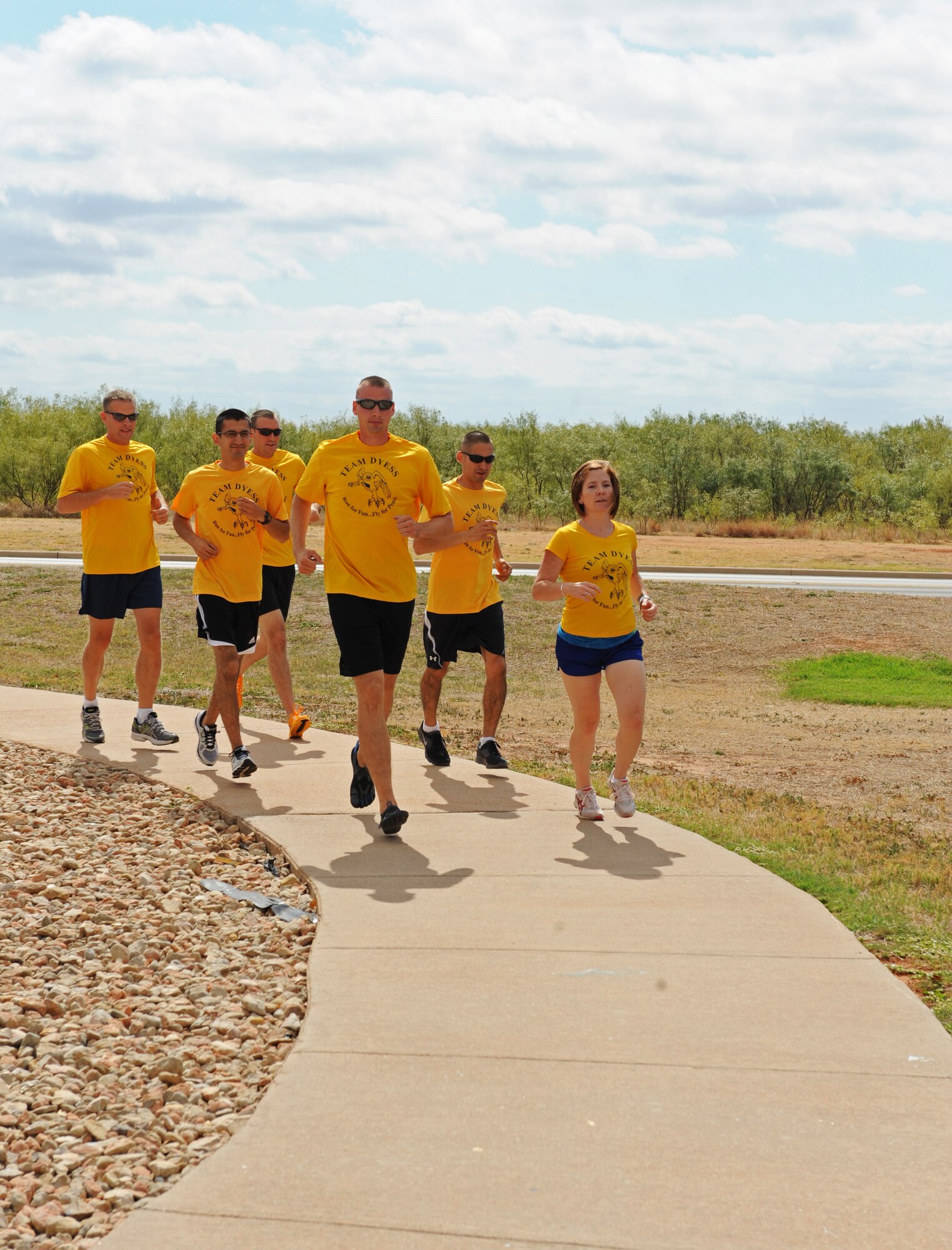 Members of Team Dyess 12-man relay team runs through the air park to train for their upcoming 223 mile relay race Oct. 6, 2011, at Dyess Air Force Base, Texas. The relay race is scheduled for Oct. 14-15 from Austin to Corpus Christi, Texas, in support of Arthritis. (U.S. Air Force photo by Airman 1st Class Peter Thompson/Released) 