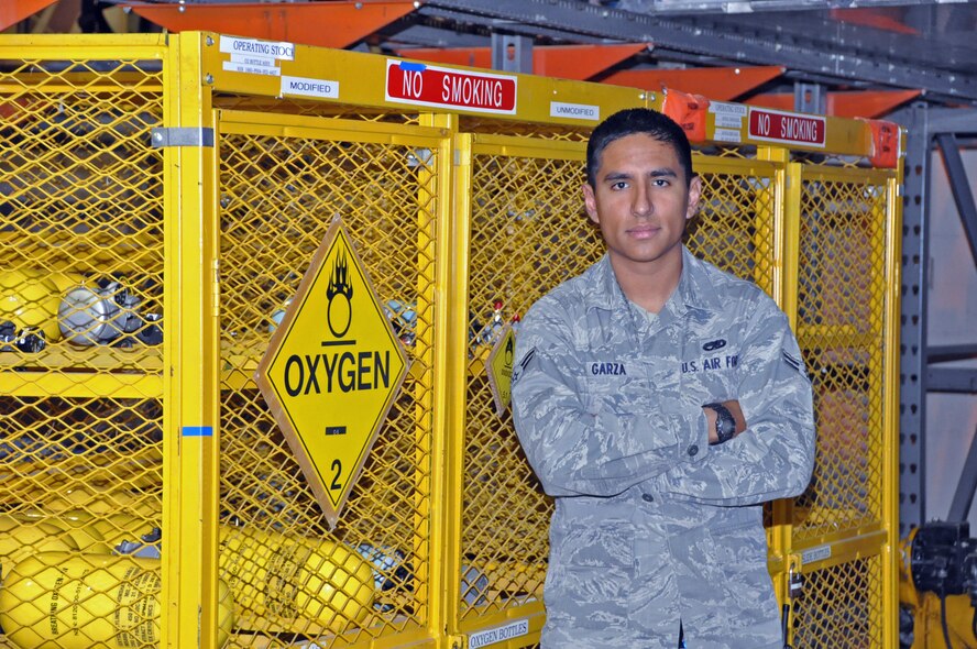 Airman 1st Class Garrett Garza, 60th Aircraft Maintenance Squadron, stands with dozens of oxygen bottles on Oct. 7, 2011, maintained by the "Dash 21" shop at Travis Air Force Base, Calif. Garza and the Airmen he works with are responsible for making sure their aircraft equipment is up to date and serviceable for those who will later fly the plane. (U.S. Air Force photo/Staff Sgt. Patrick Harrower)