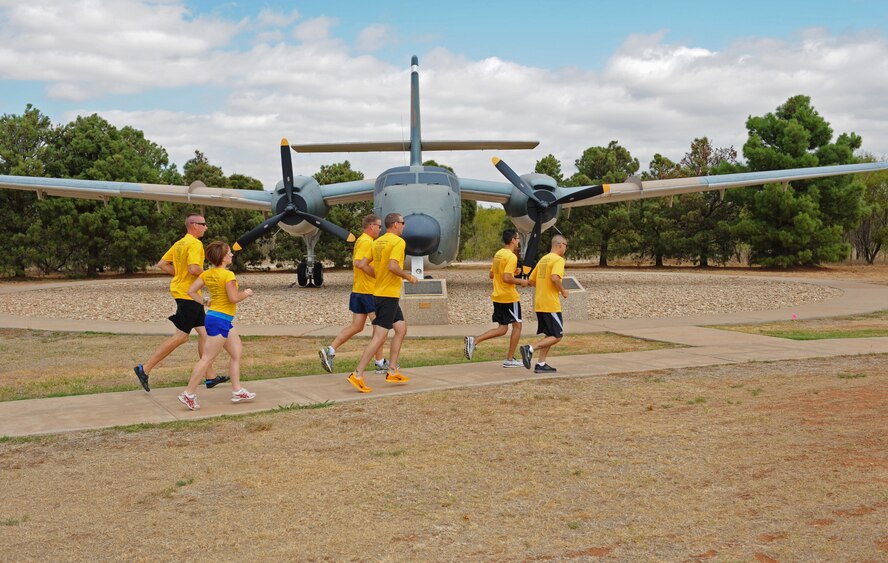 Members of Team Dyess 12-man relay team runs through the air park to train for their upcoming 223 mile relay race Oct. 6, 2011, at Dyess Air Force Base, Texas. The relay race is scheduled for Oct. 14-15 from Austin to Corpus Christi, Texas, in support of Arthritis. (U.S. Air Force photo by Airman 1st Class Peter Thompson/Released) 