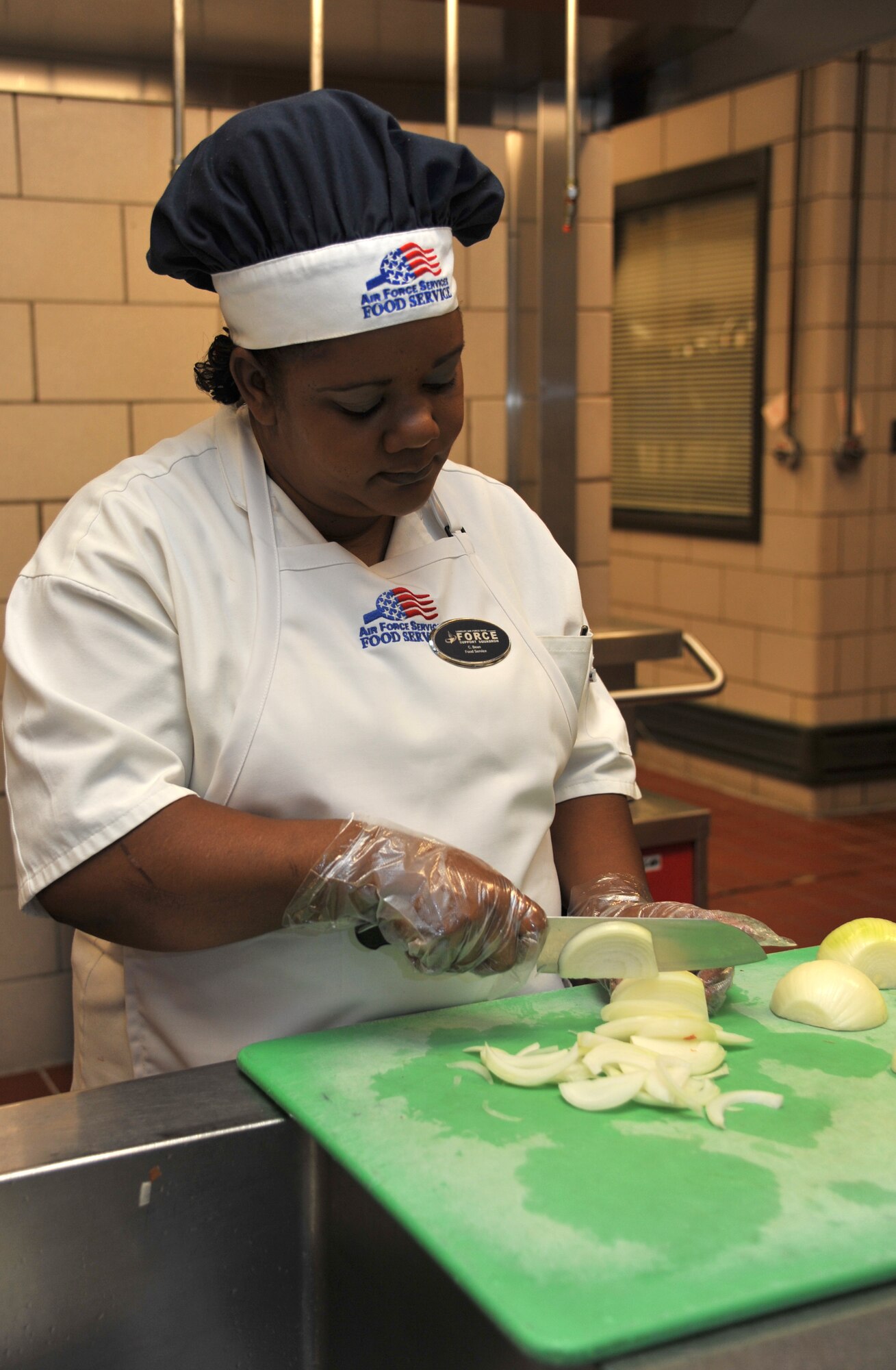 Carol Bean, 633rd Force Support Squadron cook, prepares vegetables for a meal at the Crossbow Dining Facility at Langley Air Force Base, Va., Oct. 6, 2011.  During evaluations on Nov. 7 and 8, the 633rd FSS will be competing for the 2012 Air Combat Command John L. Hennessy Trophy. (U.S. Air Force photo by Airman 1st Camilla Griffin/Released)