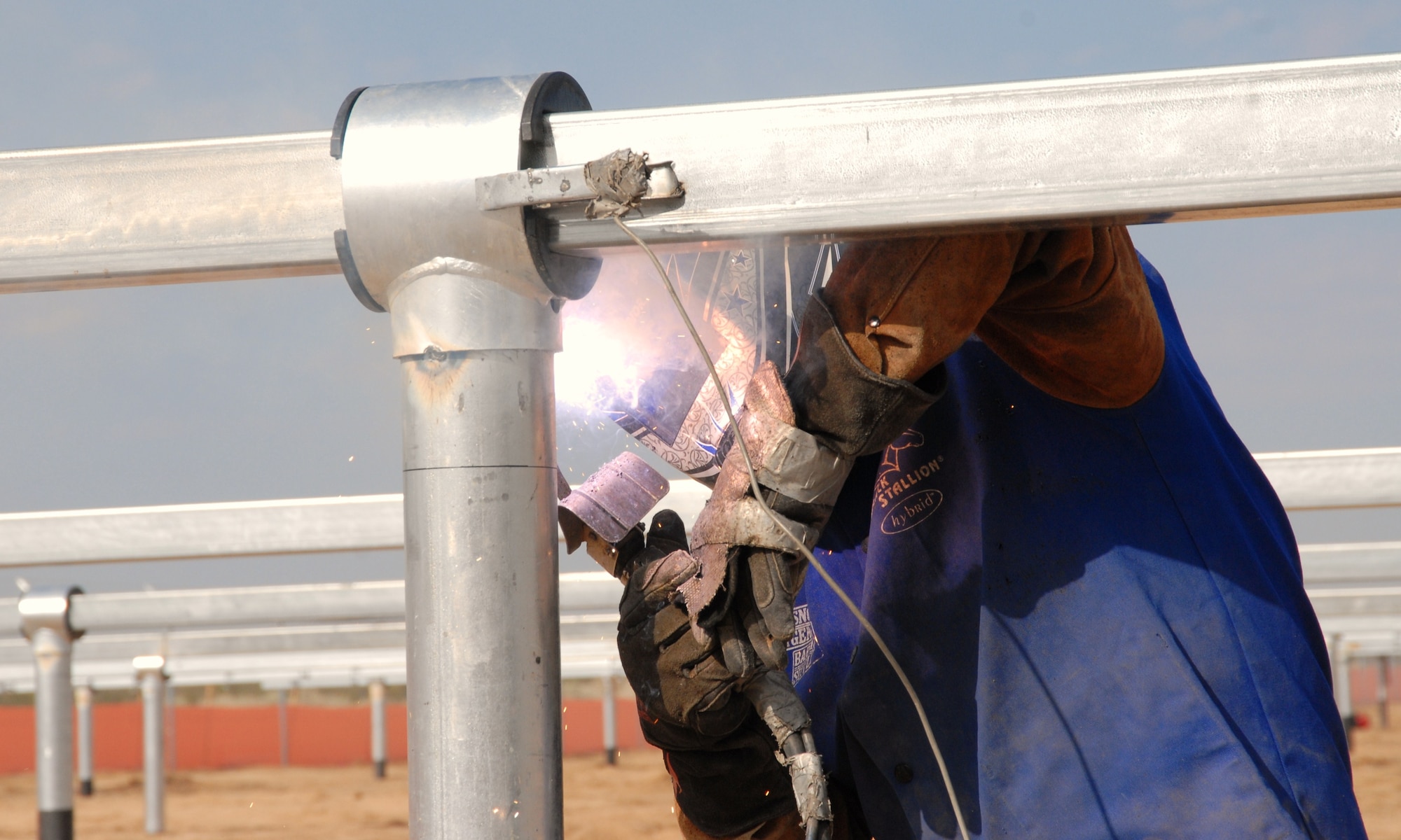 A worker welds a connection to a stand that will hold solar panels for one of the three solar farms being constructed around Edwards. One solar farm is located near Wolfe Avenue and Lancaster Boulevard, one is just off Rosamond Boulevard near the north gate and one is at the Air Force Research Laboratory Detachment 7. The locations were chosen because of the electricity substations located at each site. Once completed, the lines from the solar panels will be connected to Edwards' power grid. (Air Force photo by Dawn Waldman)