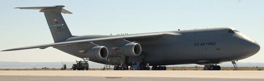 Members of the 418th Flight Test Squadron work on a C-5M Super Galaxy parked on the Edwards flightline. The massive transport aircraft from Dover Air Force Base, Del., is undergoing testing of the plane's upgraded Block 3.5 software. The C-5 can carry twice the cargo of other strategic cargo aircraft. (U.S. Air Force photo/Kenji Thuloweit) 

