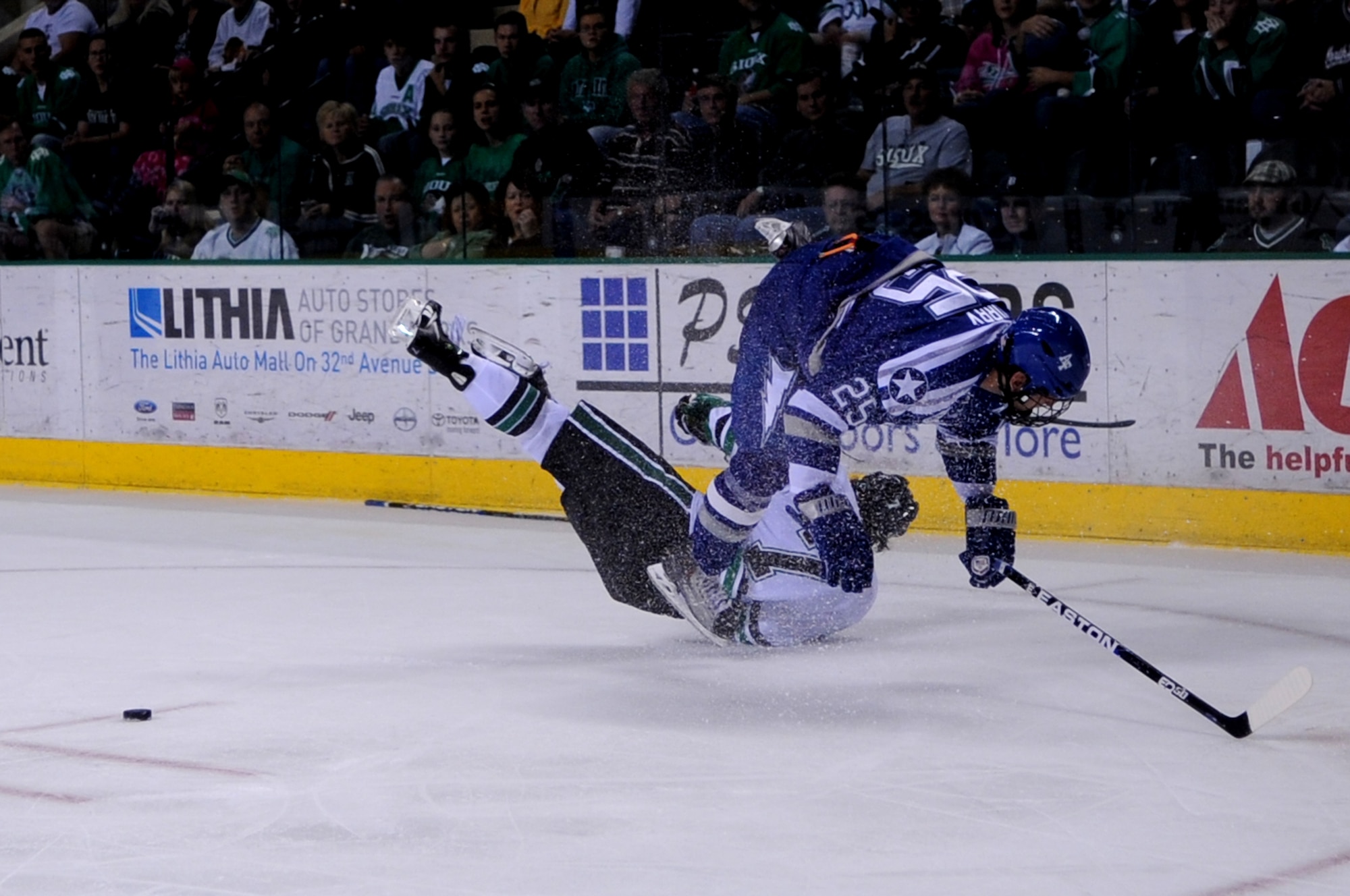 Air Force Academy senior Tim Kirby takes out University of North Dakota junior Danny Kristo while trying to take possession of the puck during the 15th annual Icebreaker Tournament at Ralph Engelstad Arena in Grand Forks, N.D., on Oct 7. The University of North Dakota Fighting Sioux took on the Falcons during the 15th annual Icebreaker Tournament with UND coming out on top 4-3. The season opener marked the 10-year anniversary of the arena. (U.S. Air Force photo by Senior Airman Amanda N. Stencil)