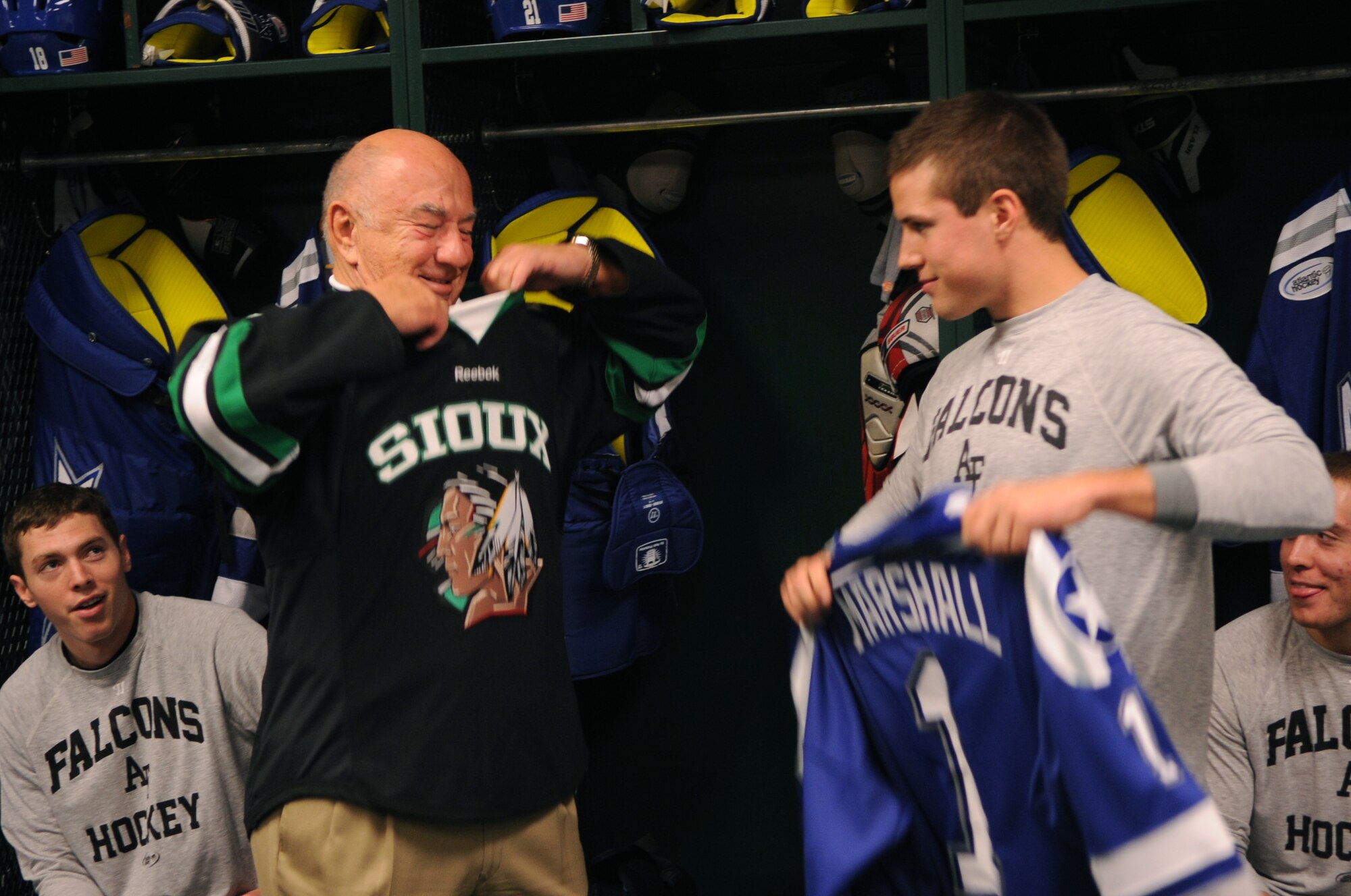 Air Force Academy senior Paul Weisgarber, captain of the Air Force Falcons hockey team, presents John Marshall, Grand Forks community leader, with an official USAFA hockey jersey at Ralph Engelstad Arena in Grand Forks, N.D., on Oct 7. The University of North Dakota Fighting Sioux took on the Falcons during the 15th annual Icebreaker Tournament with UND coming out on top 4-3. The season opener marked the 10-year anniversary of the arena.  (U.S. Air Force photo by Senior Airman Amanda N. Stencil)