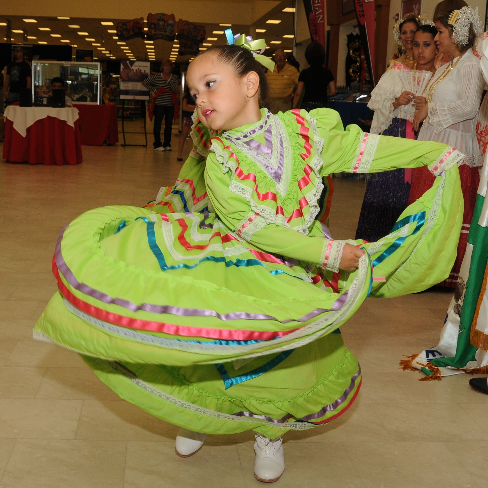 Five-year-old Brianna Rinza, daughter of Norma and Hector Rinza of Gautier, performs a traditional Mexican dance with Vicentenario de Mexico group Oct. 8 during the Hispanic Heritage Month celebration at the main exchange, Keesler Air Force Base, Miss. The Panama Without Borders Folkloric Dance Group from Biloxi headlined the program and performed 12 dances attired in traditional Panamanian costumes.  (U.S. Air Force photo by Kemberly Groue)