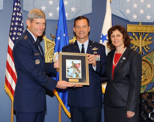 Air Force Chief of Staff Gen. Norton Schwartz presents Brig. Gen. Mark and Sara Dillon with the traditional Gen. and Mrs. Jerome F. O’Malley Award legacy picture during a Pentagon ceremony Oct. 11, 2011, in Washington, D.C. The Dillons were honored with the award, presented annually to the wing commander and spouse whose contributions to the nation, Air Force and local community best exemplifies the highest ideals and positive leadership of a military couple in wing command positions. (U.S. Air Force photo/Andy Morataya)