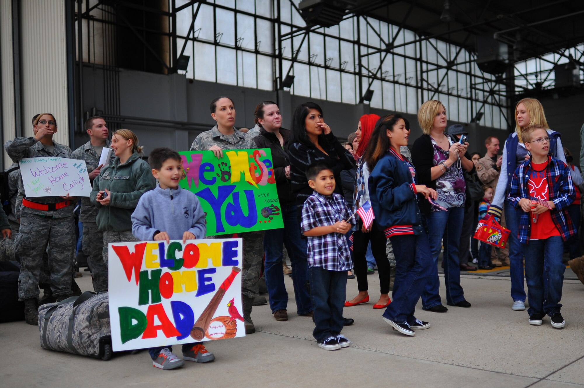 SPANGDAHLEM AIR BASE, Germany – Airmen and families await the arrival of their returning family members during a deployment return function here Oct. 11. The returning Airmen were a part of the maintenance support for the 480th Fighter Squadron while they while deployed in support of Operation New Dawn. (U.S. Air Force photo/Airman 1st Class Dillon Davis)