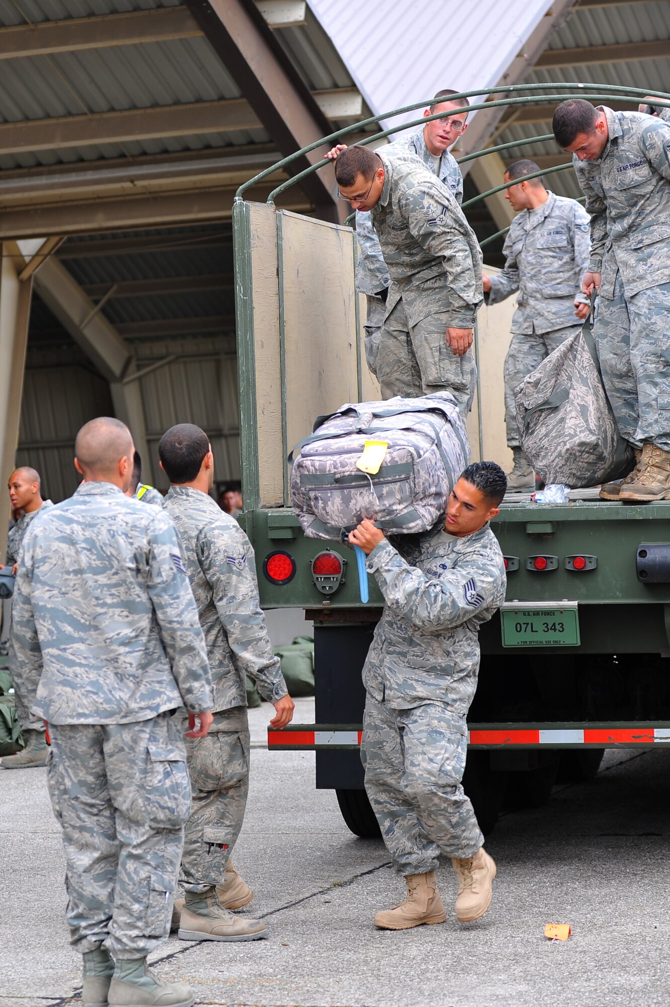 SPANGDAHLEM AIR BASE, Germany – Airmen assigned to the 52nd Fighter Wing unload luggage from a truck during a deployment return function here Oct. 11. The returning Airmen were a part of the maintenance support for the 480th Fighter Squadron while they while deployed in support of Operation New Dawn. (U.S. Air Force photo/Airman 1st Class Dillon Davis)