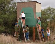 LAUGHLIN AIR FORCE BASE, Texas - Scouts from troop 255 and volunteers from First Christian Church in Del Rio repair and paint a deer blind on base. The workers repaired the stands on Oct. 8, as part of an Eagle Scout project. (U.S. Air Force photo/Master Sgt. Peter Borys)