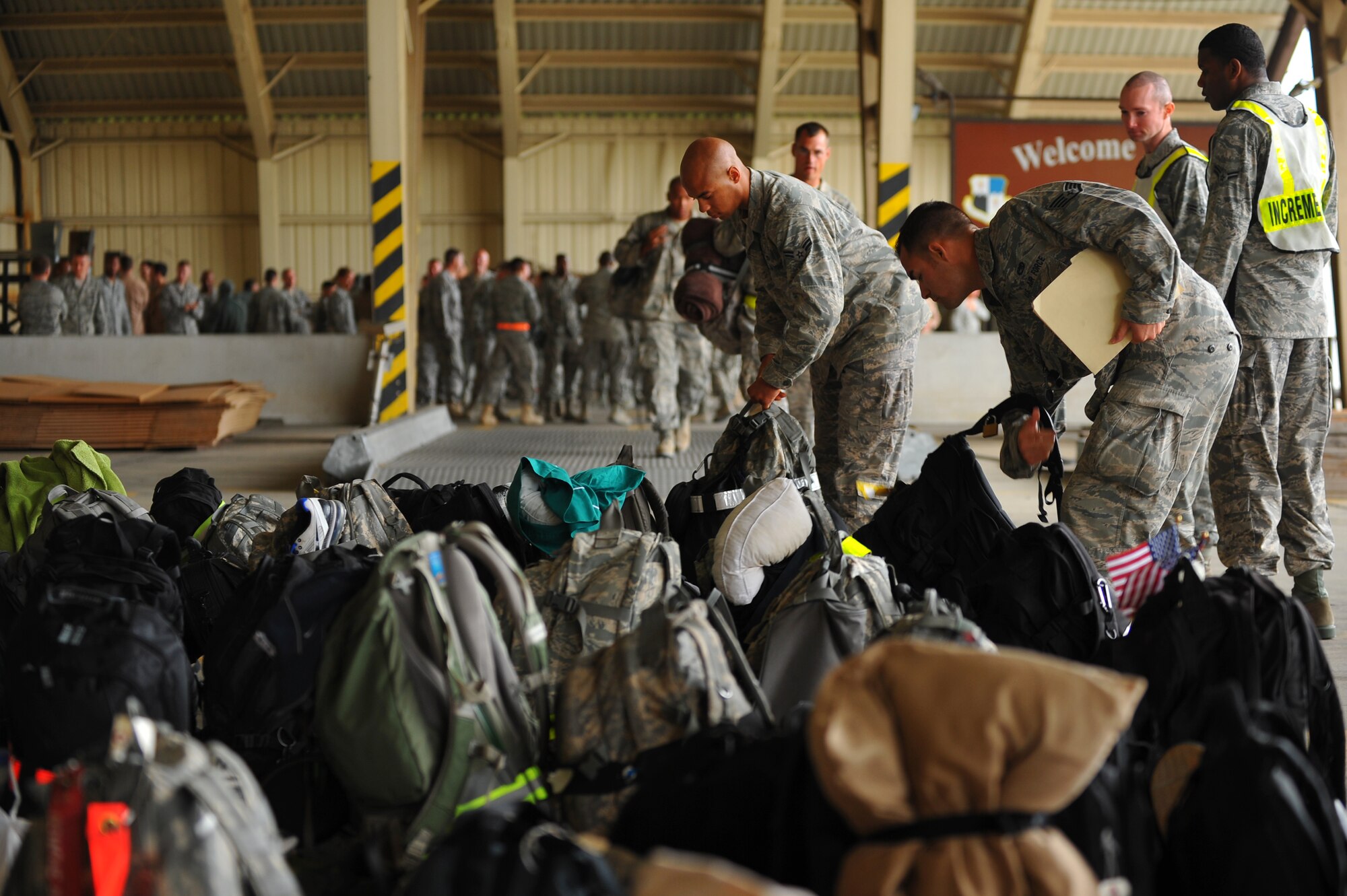 SPANGDAHLEM AIR BASE, Germany – Airmen assigned to the 52nd Maintenance Group drop off their luggage to be searched during a deployment return function here Oct. 11. The returning Airmen were a part of the maintenance support for the 480th Fighter Squadron while they while deployed in support of Operation New Dawn. (U.S. Air Force photo/Airman 1st Class Dillon Davis)