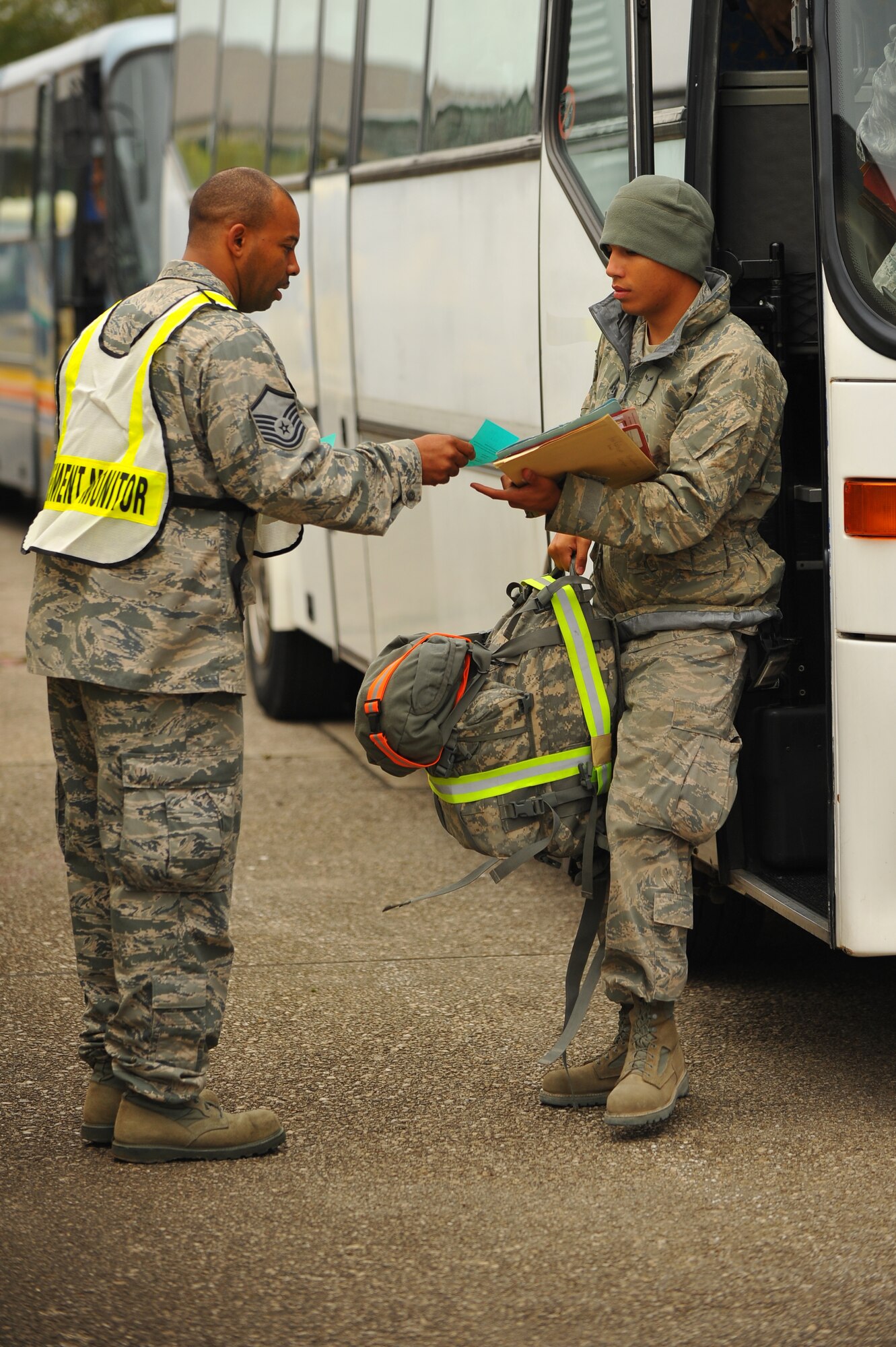 SPANGDAHLEM AIR BASE, Germany – Master Sgt. Mark Childs, 52nd Force Support Squadron, hands a pamphlet to Airman 1st Class Antonio Rodriguez, 52nd Equipment Maintenance Squadron conventional maintenance crew member journeyman, during a deployment return function here Oct. 11. The returning Airmen were a part of the maintenance support for the 480th Fighter Squadron while they while deployed in support of Operation New Dawn. (U.S. Air Force photo/Airman 1st Class Dillon Davis)