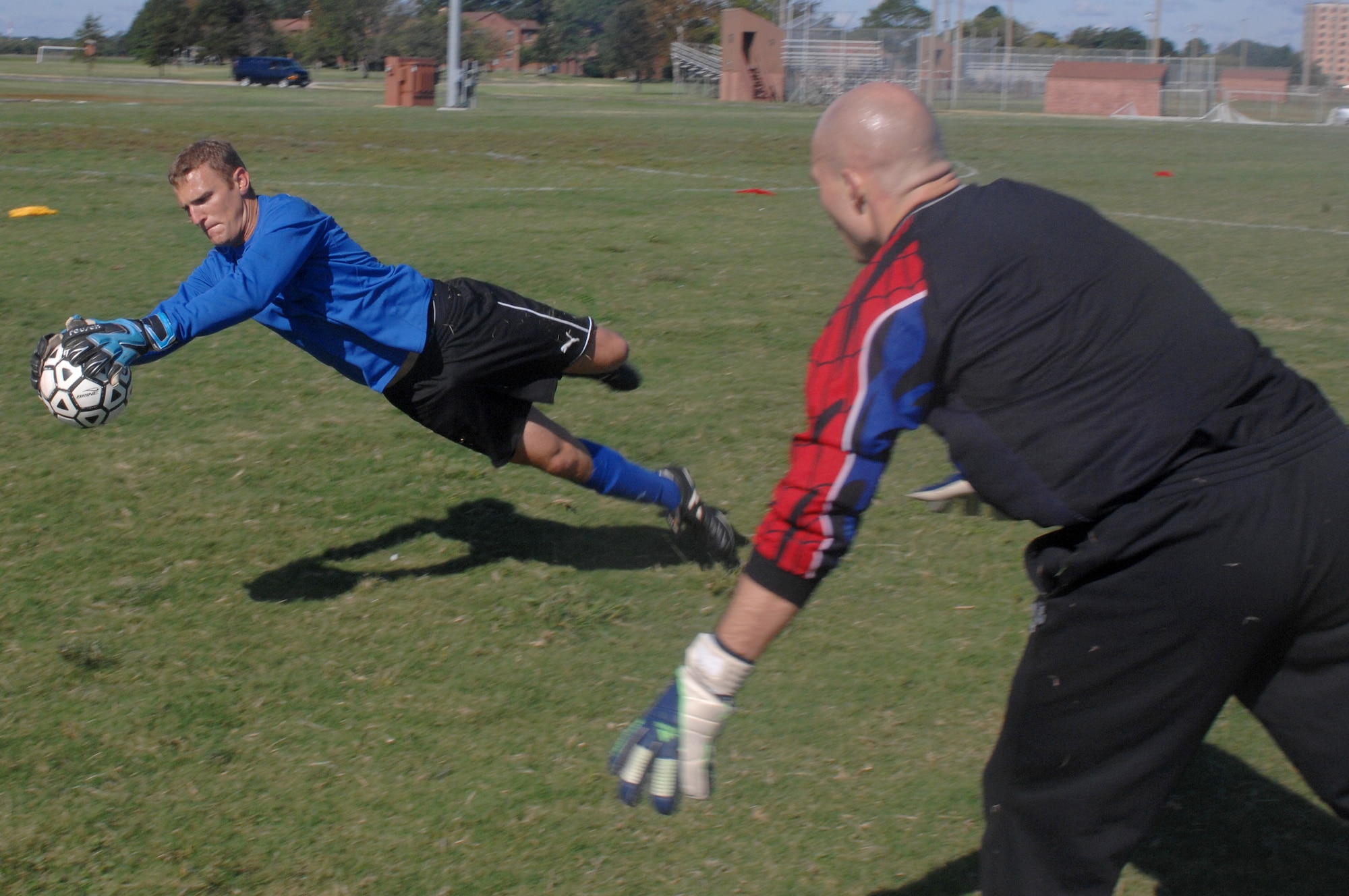 Joe Dills, goalkeeper, tosses the ball to returning player Paul Elsbernd, goalkeeper, during a pass and catch drill during the All Air Force Soccer Trial and Training Camp held at Langley Air Force Base, Va., Oct. 4, 2011. Soccer players from all over the world are taking part in three weeks of soccer trials to be evaluated for a spot on the 2011-2012 All Air Force, Men’s Soccer Team. (U.S. Air Force photo by Staff Sgt. Antoinette Gibson/Released)