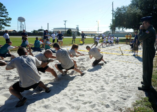 Airmen from Team 14 from the Operations Group participate in the Tug-of-War  at the Festival of Fitness Oct.7, at Joint-Base Charleston.Seventeen, six-man teams competed in the Festival of Fitness which included a 5k run, tug-of-war, trivia questions and a team fitness relay. The 628th Civil Engineer Squadron Lime Green Team was named the overall winner.  (U.S. Air Force photo/Airman 1st Class Ashlee Galloway)