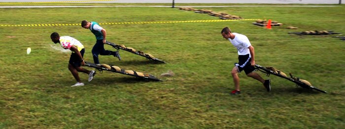 Airmen pull litters while competing in the team relays at the Festival of Fitness Oct. 7, at Joint-Base Charleston. Seventeen, six-man teams competed in the Festival of Fitness which included a 5k run, tug-of-war, trivia questions and a team fitness relay.The 628th Civil Engineer Squadron Lime Green Team was named the overall winner.  (U.S. Air Force photo/Airman 1st Class Ashlee Galloway)