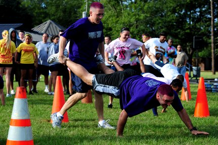 Technical Sgt. Jory Ohmer and Airman 1st Class Bryan Queen from the Purple Cobras team, move through the cones while competing in the human wheel barrel competition during the Festival of Fitness  Oct. 7, at Joint Base Charleston.   Seventeen, six-man teams competed in the Festival of Fitness which included a 5k run, tug-of-war, trivia questions and a team fitness relay. The 628th Civil Engineer Squadron Lime Green Team was named the overall winner. (U.S. Air Force photo/ Staff Sgt. Nicole Mickle)  