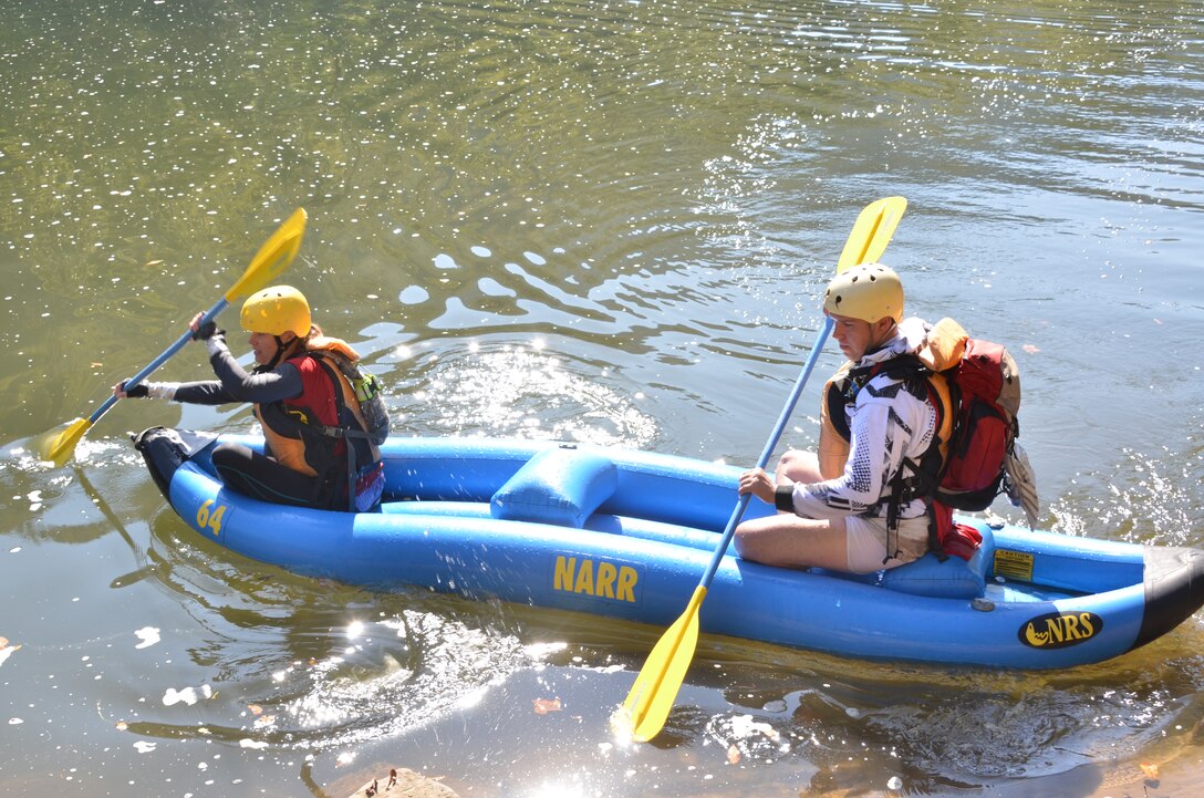 U.S. Army Staff Sgt. Kimberly Brandmeyer and Sgt. 1st Class Steven Burge, Team America Global Police, finish the “duckie” race of the 11th Annual Wilderness Challenge, Oct. 8, 2011, in Fayetteville W.Va. During this part of the competition, competitors navigated class 1-3 rapids in their inflatable canoe on the New River. (U.S. Air Force photo by Tech. Sgt April Wickes/Released)
