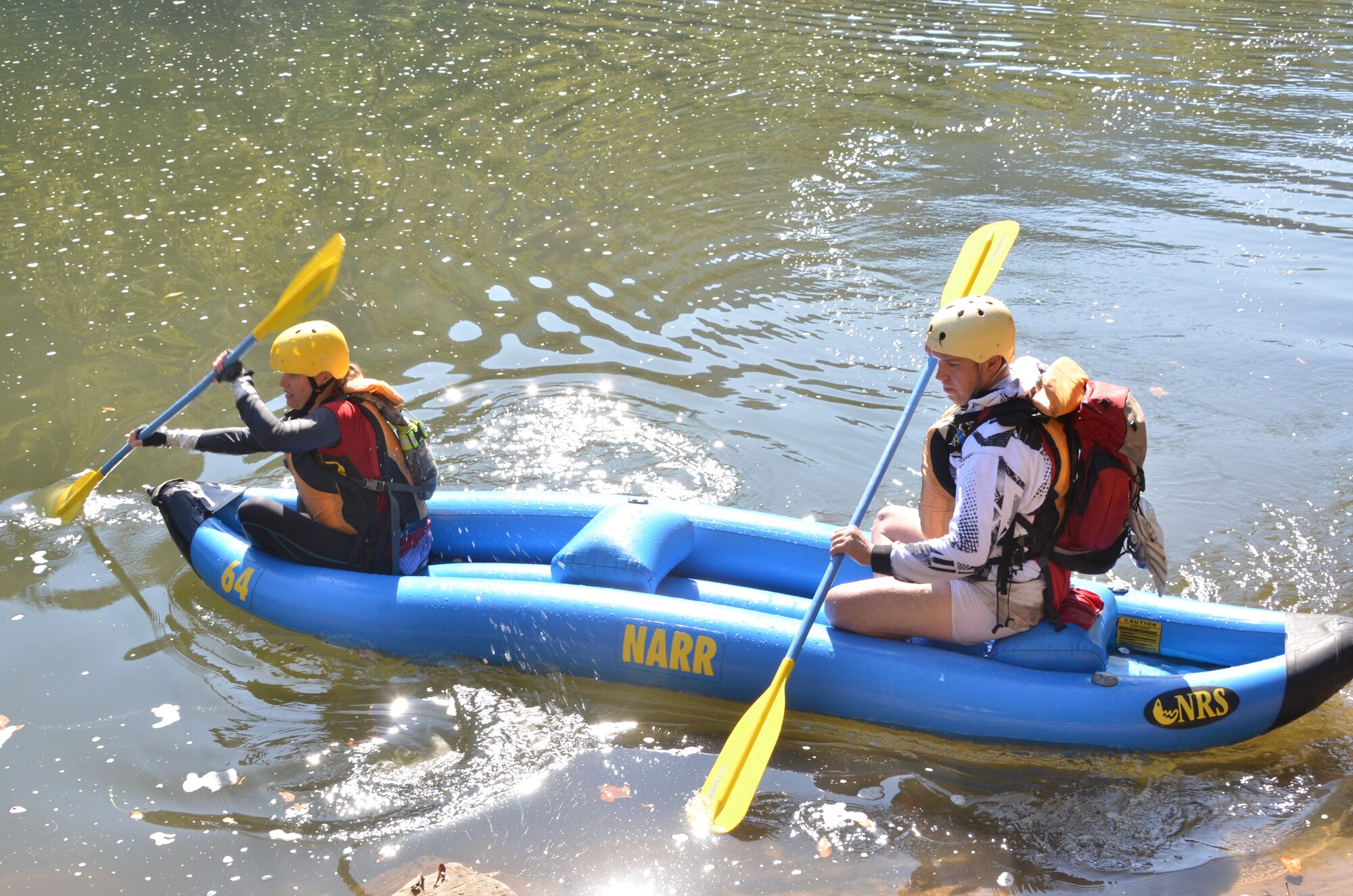 U.S. Army Staff Sgt. Kimberly Brandmeyer and Sgt. 1st Class Steven Burge, Team America Global Police, finish the “duckie” race of the 11th Annual Wilderness Challenge, Oct. 8, 2011, in Fayetteville W.Va. During this part of the competition, competitors navigated class 1-3 rapids in their inflatable canoe on the New River. (U.S. Air Force photo by Tech. Sgt April Wickes/Released)