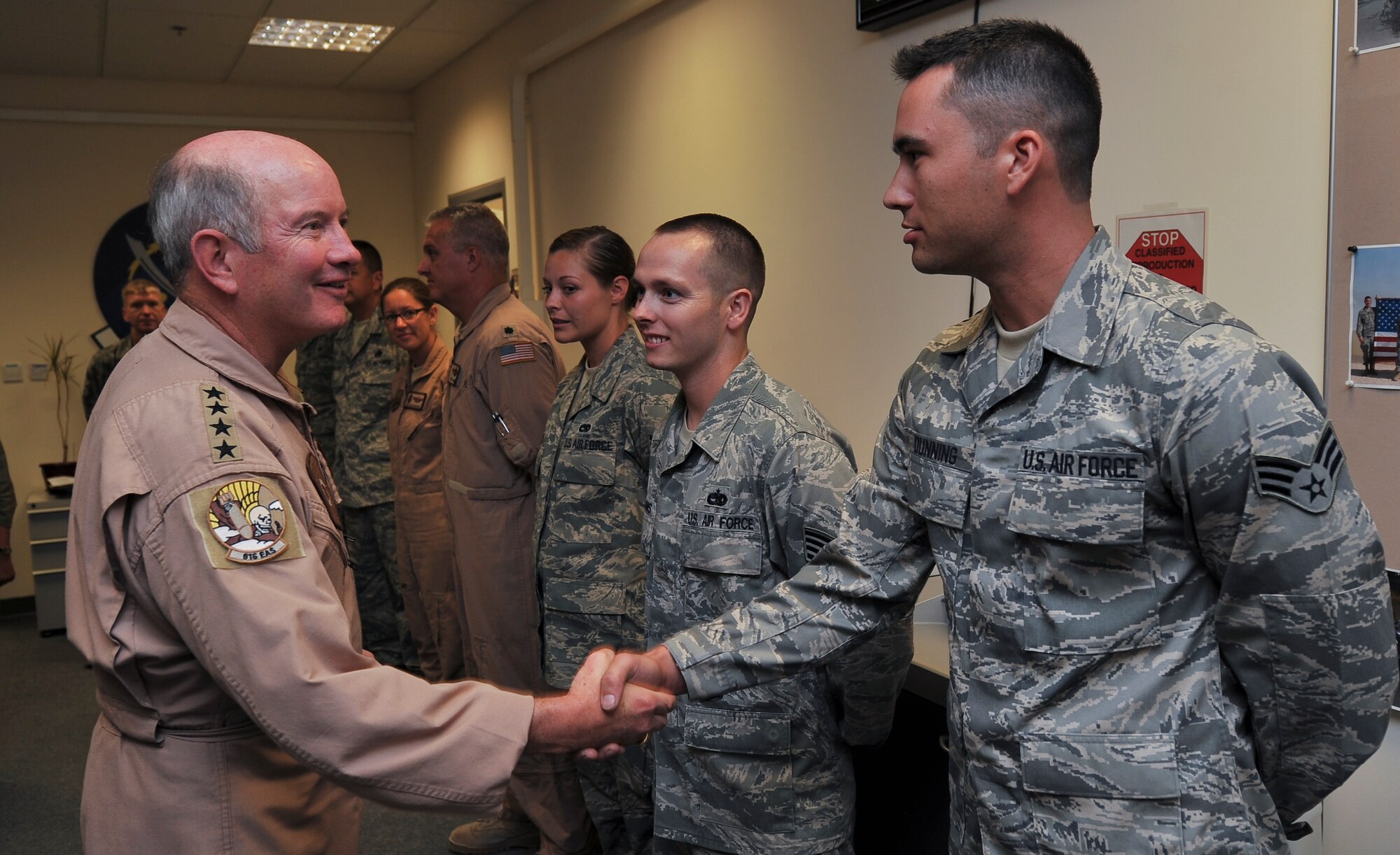 Gen. Duncan J. McNabb, commander,  U.S. Transportation Command, greets Senior Airman Michael Dunning, 340th Expeditionary Aircraft Maintenance Unit KC-135 crew chief, Oct. 4, 2011, at an undisclosed location in Southwest Asia. McNabb’s visit was just one stop on a tour of bases throughout the U.S. Central Command Area of Responsibility to thank servicemembers for their sacrifice and dedication. USTRANSCOM is the single manager for global air, land and sea transportation for the Department of Defense. The general is scheduled to retire Nov. 30, 2011, after more than three decades of service. Dunning, a native of Landstuhl, Germany, is deployed from Tinker Air Force Base, Okla. (U.S. Air Force photo/Senior Airman Paul Labbe) 