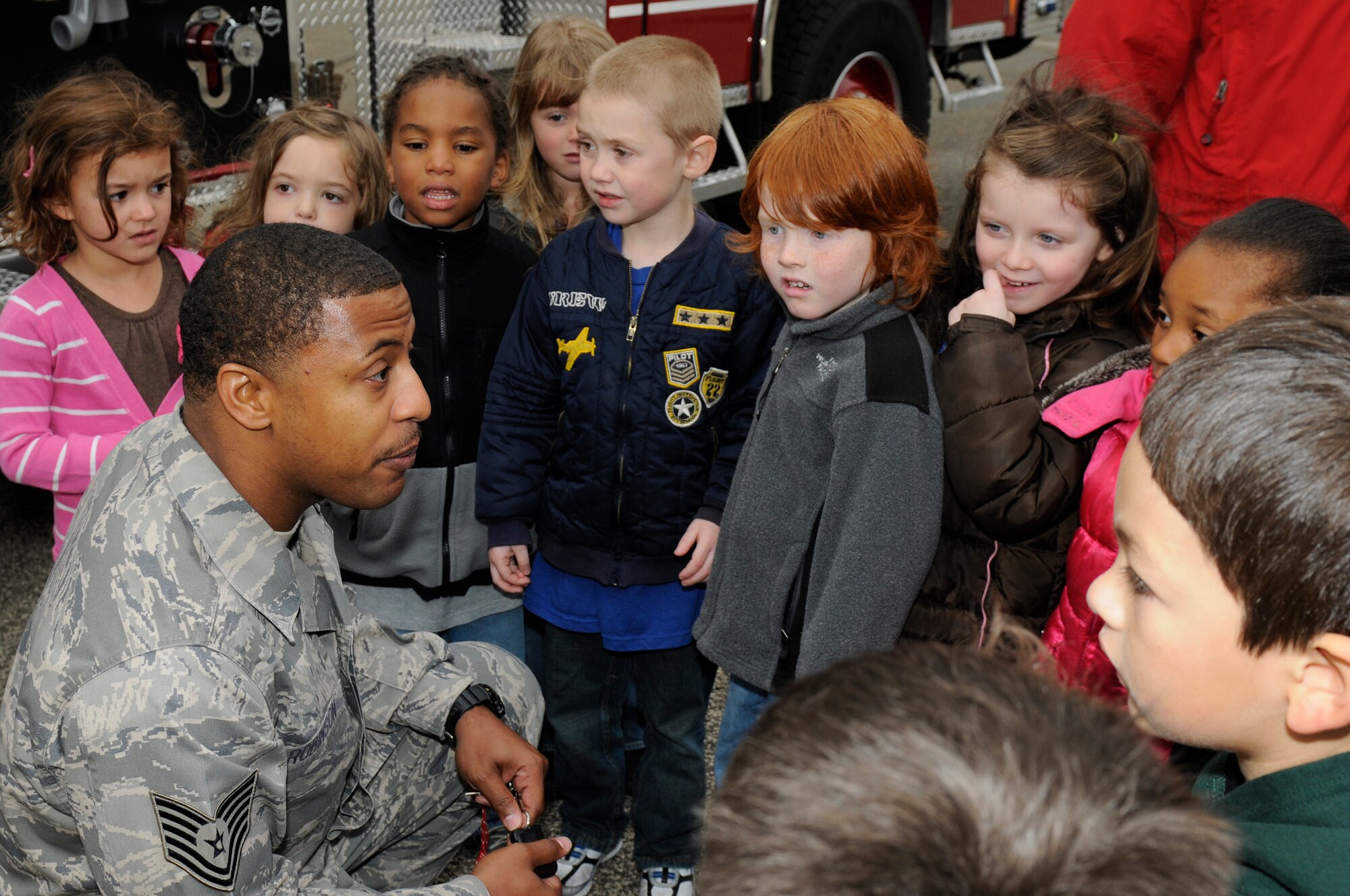 SPANGDAHLEM AIR BASE, Germany -- Tech. Sgt. Daniel Robinson, 52nd Civil Engineer Squadron NCO in charge of fire prevention, teaches safety to children from the Spangdahlem Elementary School fire here Oct. 12. National Fire Prevention Week is a week-long schedule of events that promotes fire safety and prevention through demos, visits from Sparky the Fire Dog and a parade in Spangdahlem housing. (U.S. Air Force photo/Airman 1st Class Brittney Frees)